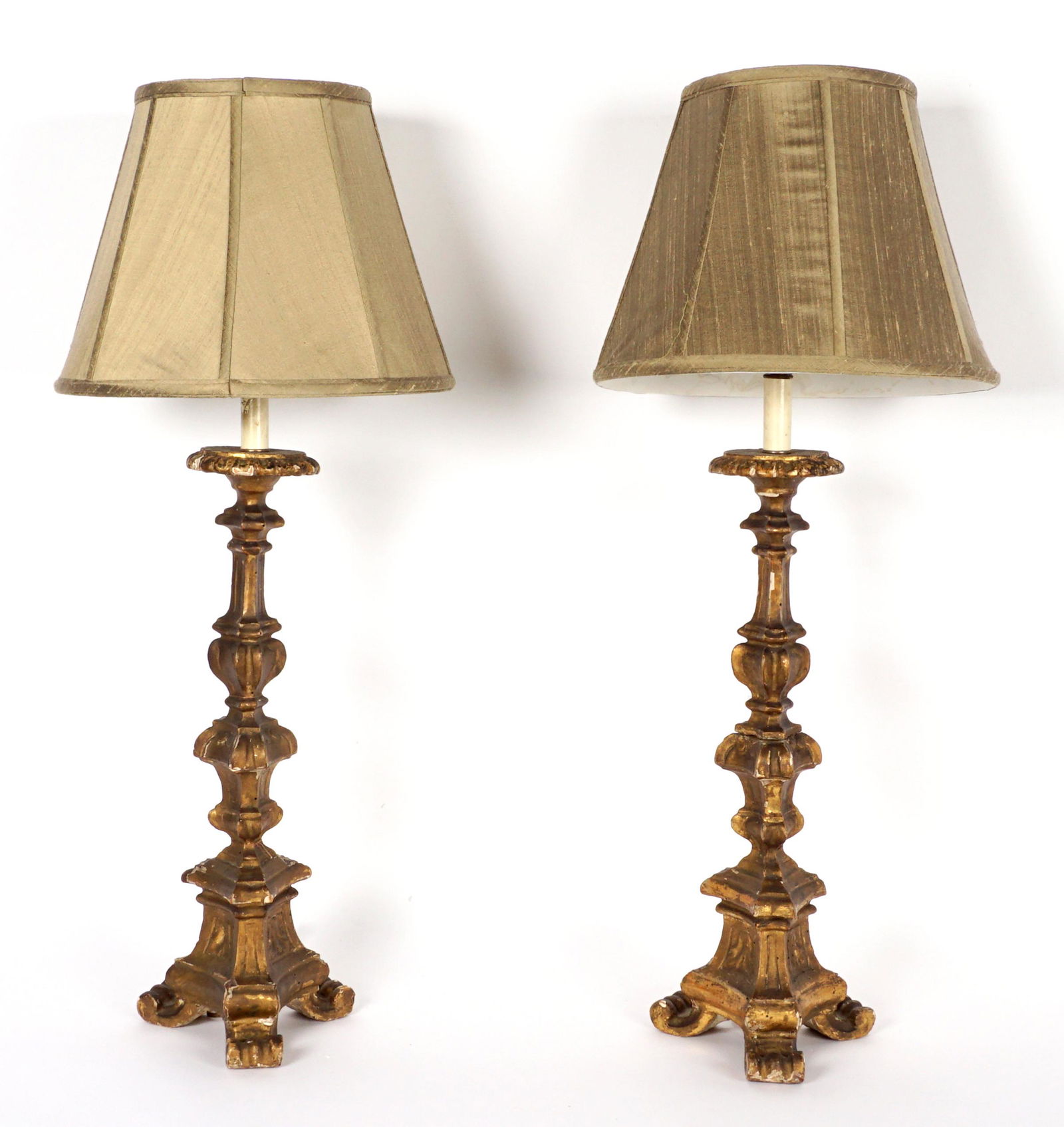 Pair Early Italian Carved Gilt Wood Pricket Lamps: 18th Century carved gilt wood pricket sticks mounted as lamps, single socket fixtures, overall 34.75" h. x 7". Condition: Chips and loss to gilt.