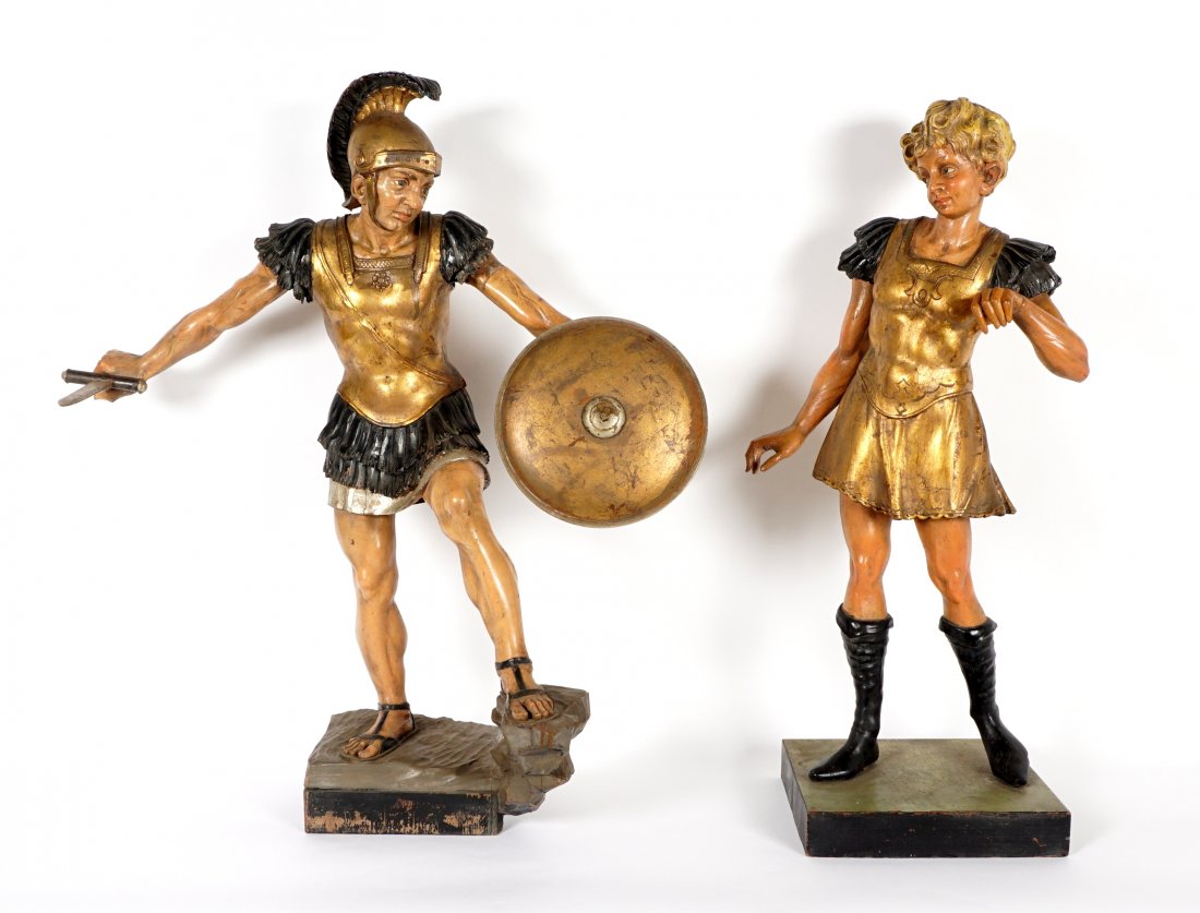 Pair 19th C. Carved Polychrome Roman Soldiers: Two large carved polychrome painted figures to include 1) Figure of Roman soldiers with shield and short sword, overall 39" h. x 34.5" x 17". 2) Female figure with long sword, approx. 38.5" h. x 17" x