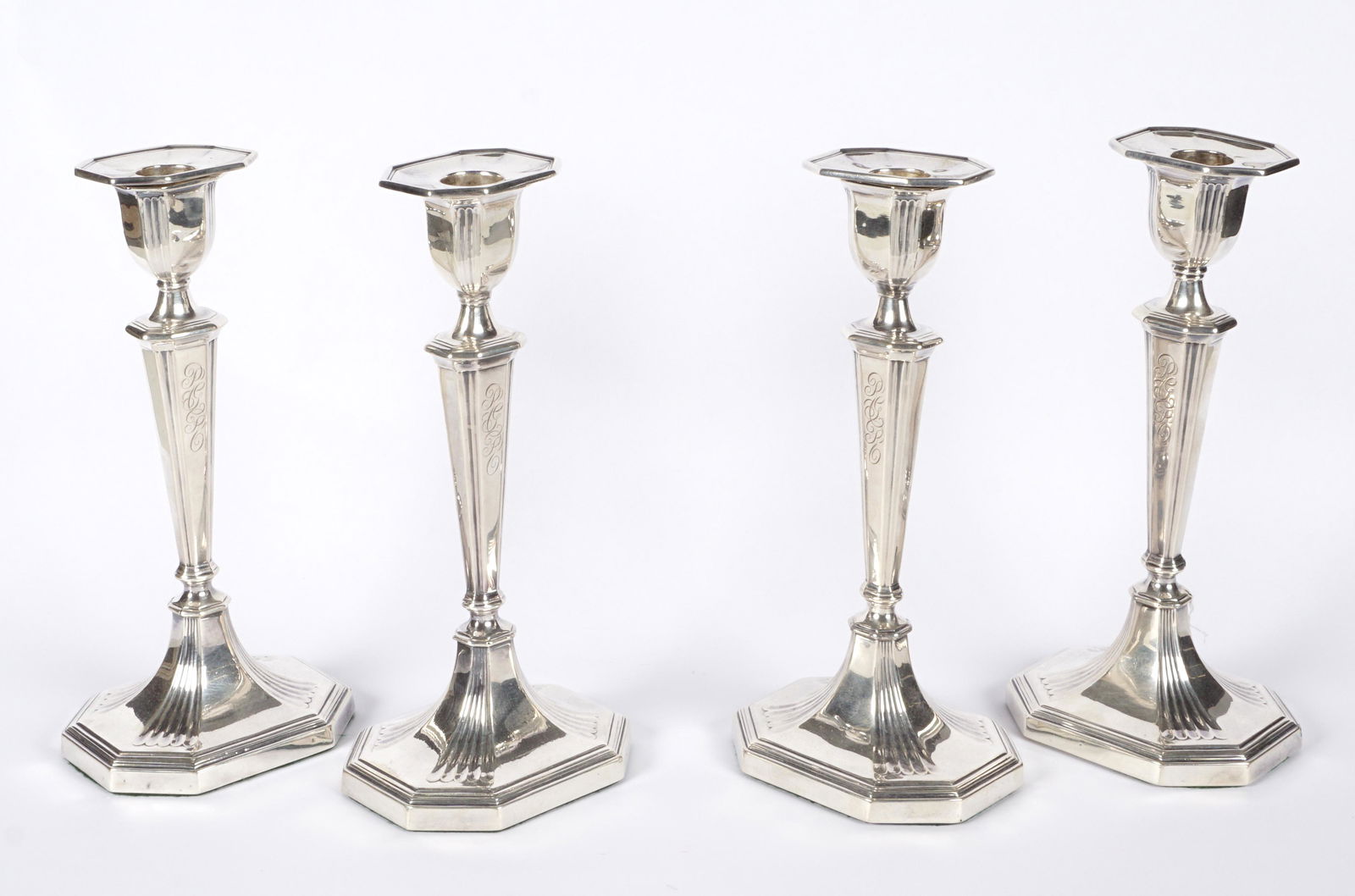 Four William Hutton & Sons Silver Candlesticks: Circa 1909 William Hutton & Sons, matched set of four candlesticks, well marked, weighted bases. Overall 9.25" h. x 4.25" x 3.5". Condition: Cleaning scratches, minor dings.