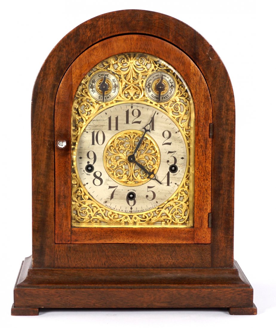 Waterbury Shelf Clock: Arched mahogany case, mixed metal silvered and brass dial marked Waterbury Clock Co. Time and strike movement also marked Waterbury, overall 14.25" h. x 13.25" x 8.25". Condition: Streaking to silver