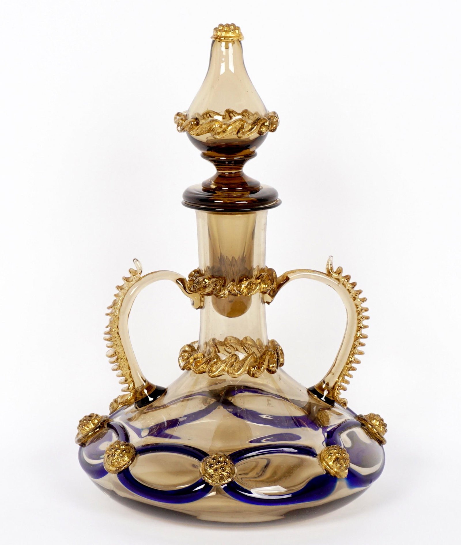 Barovier & Toso Italian Art Glass Decanter: Amber glass double handled decanter attributed to Barovier and Toso, blue glass accents, complete with stopper. Overall measures 9.5" h. x 6.5".