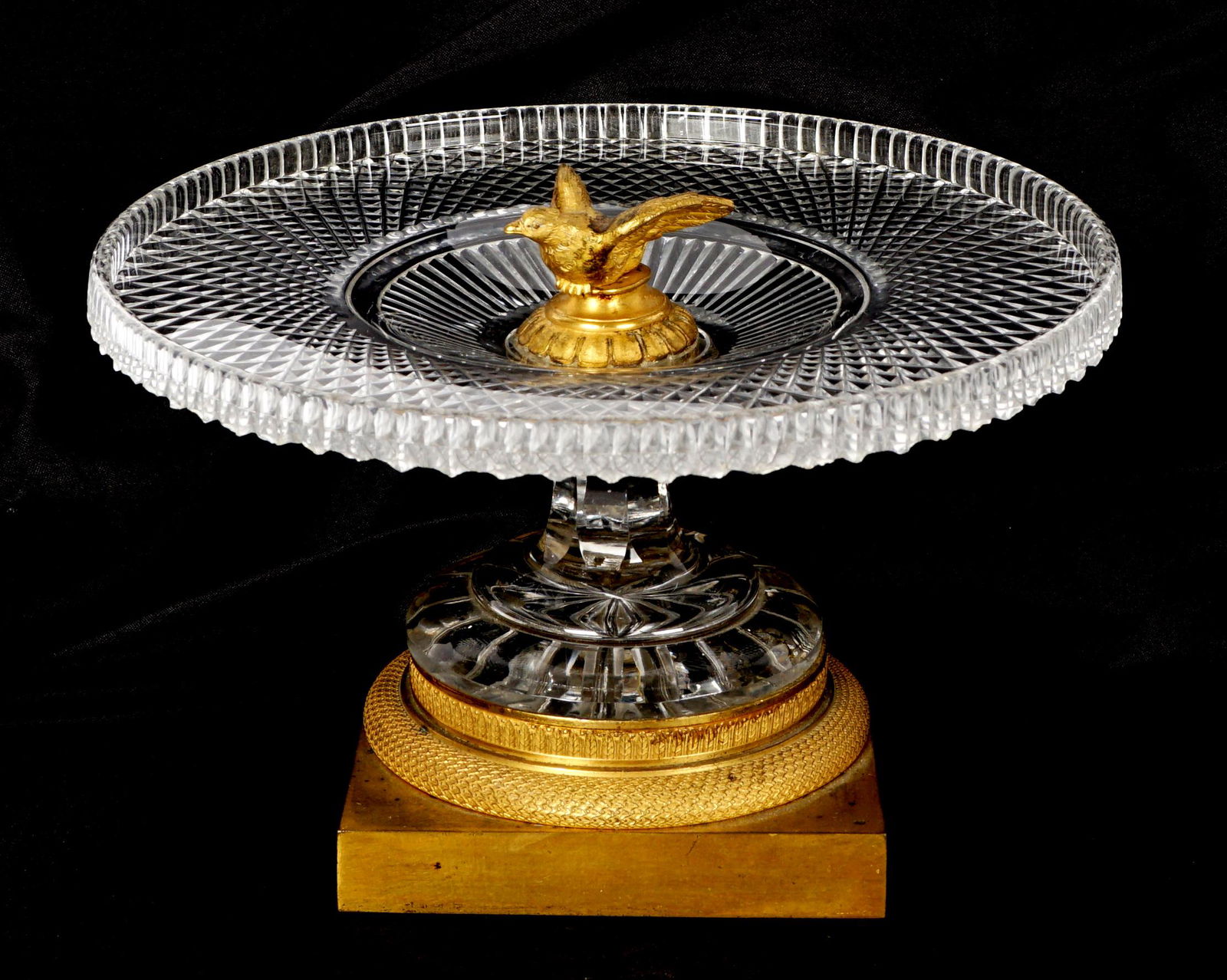 French Gilt Bronze & Cut Glass Figural Dove Tazza: Figural dove final over cut glass bowl and pedestal, bronze base, overall 5.75" h .x 9.25". Condition: Bowl slightly askew, spotting to bronze, the occasional fleabite may be discovered.
