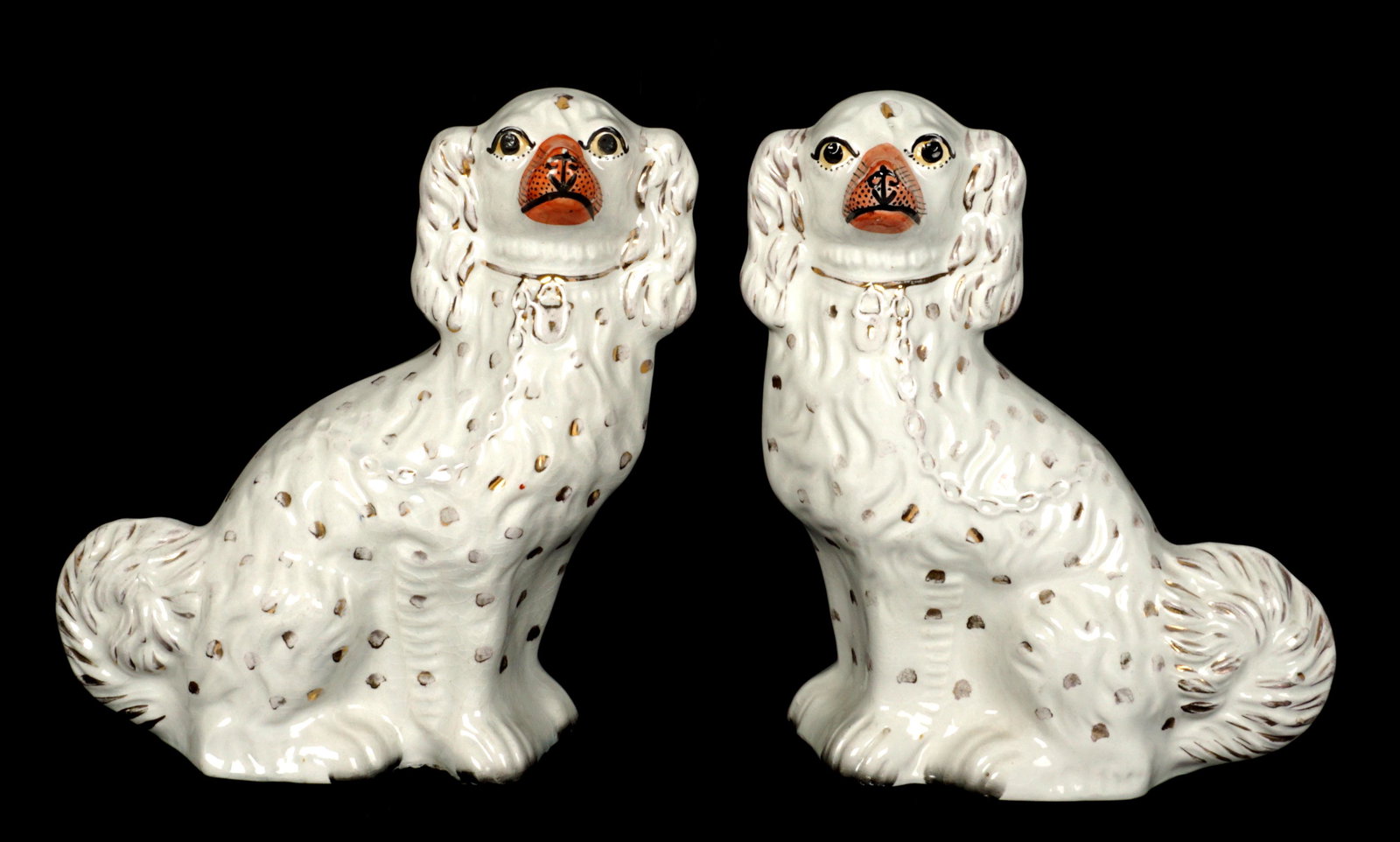 Pair Staffordshire Dogs: Pair with chains, lock collars, gilt decoration. 12" h. x 10" x 4". Condition: Crazing, minor loss of decoration. No chips, cracks, or repairs noted under blacklight.