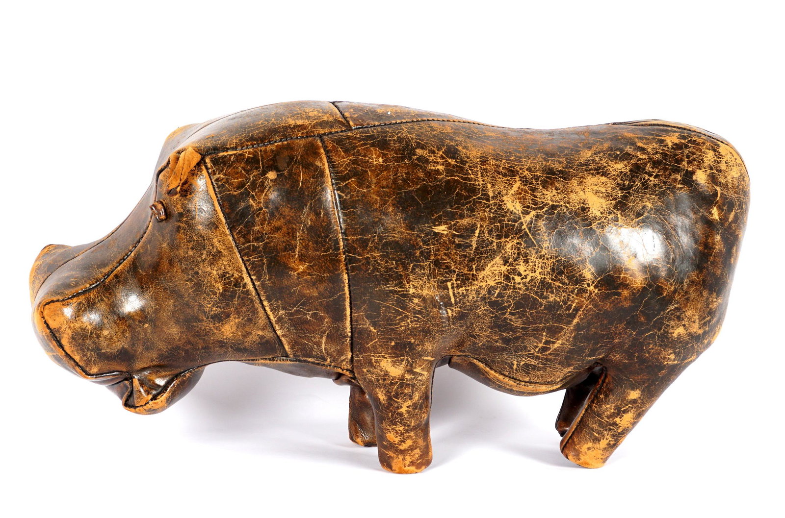 Dmitri Omersa Vintage Leather Hippo Footstool: Dmitri Omersa for Abercrombie & Fitch, hippopotamus form stitched leather foot stool, rolled leather eyes, tacked feet, overall 15" h .x 32.5" x 10". Condition: Missing ear, scratches, and wear.