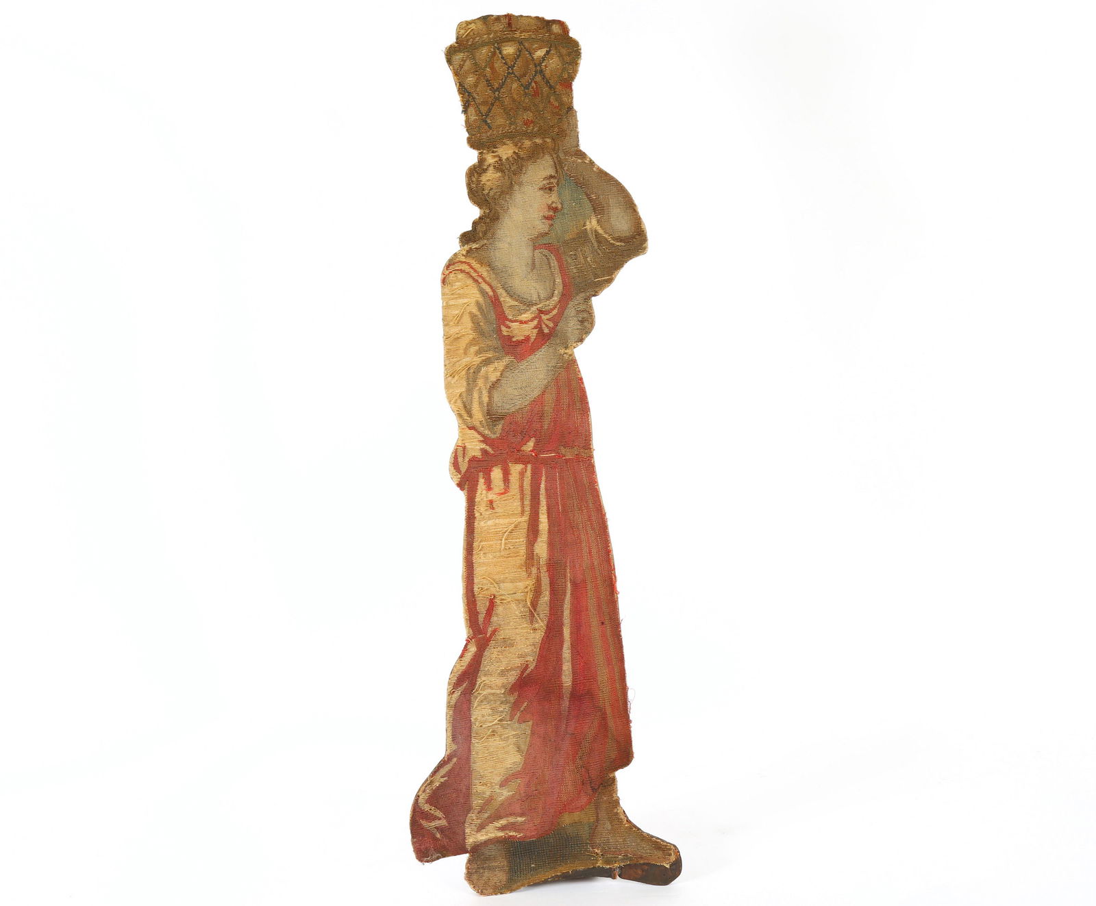 18th C. Tapestry Dummy Board Woman with Basket: Figural oak dummy board with applied tapestry cut out of a woman with a basket on her head, weighted back stand, overall 35.5" h. x 11.25" x 5.5". Condition: Wear, fading to fabric.