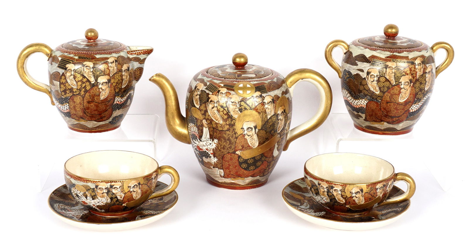 Seven Pieces Satsuma Tea Set: Scholars motif, seven pieces total to include teapot, 6" h. x 8.5", covered sugar, covered creamer, 2 teacups and saucers.