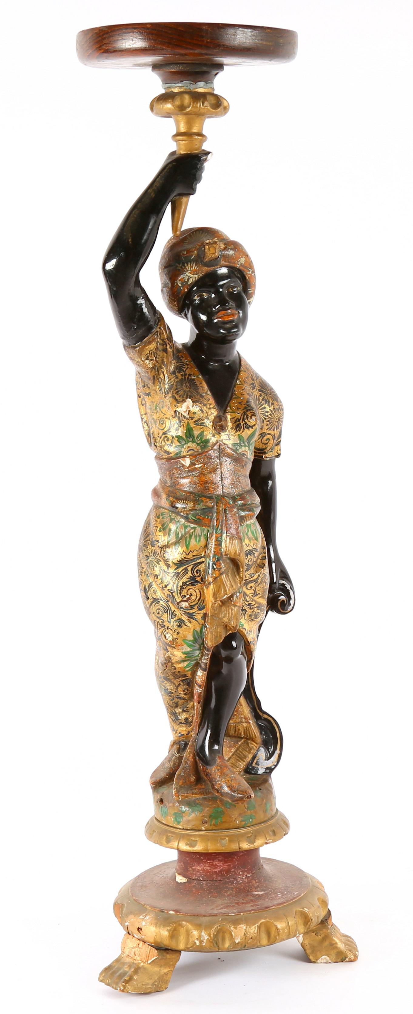 Italian Carved Polychrome Blackamoor Plant Stand: 19th Century, figure of a standing blackamoor woman, carved pedestal base on three feet. Overall 32.5" h. x 12" base dia. Condition: Paint chips, top slightly askew.