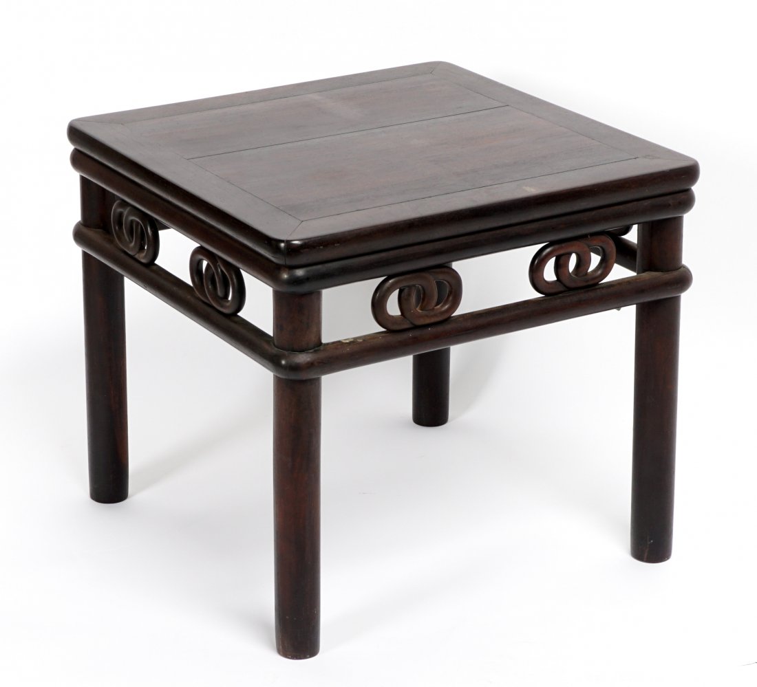 Chinese Carved Low Table / Stand: Heavy exotic wood side table, square top, open work carved skirt with interlocking rings, turned legs. Overall 18.25" h. x 20" x 20". Condition: Scratches and abrasions, other wear consistent with age
