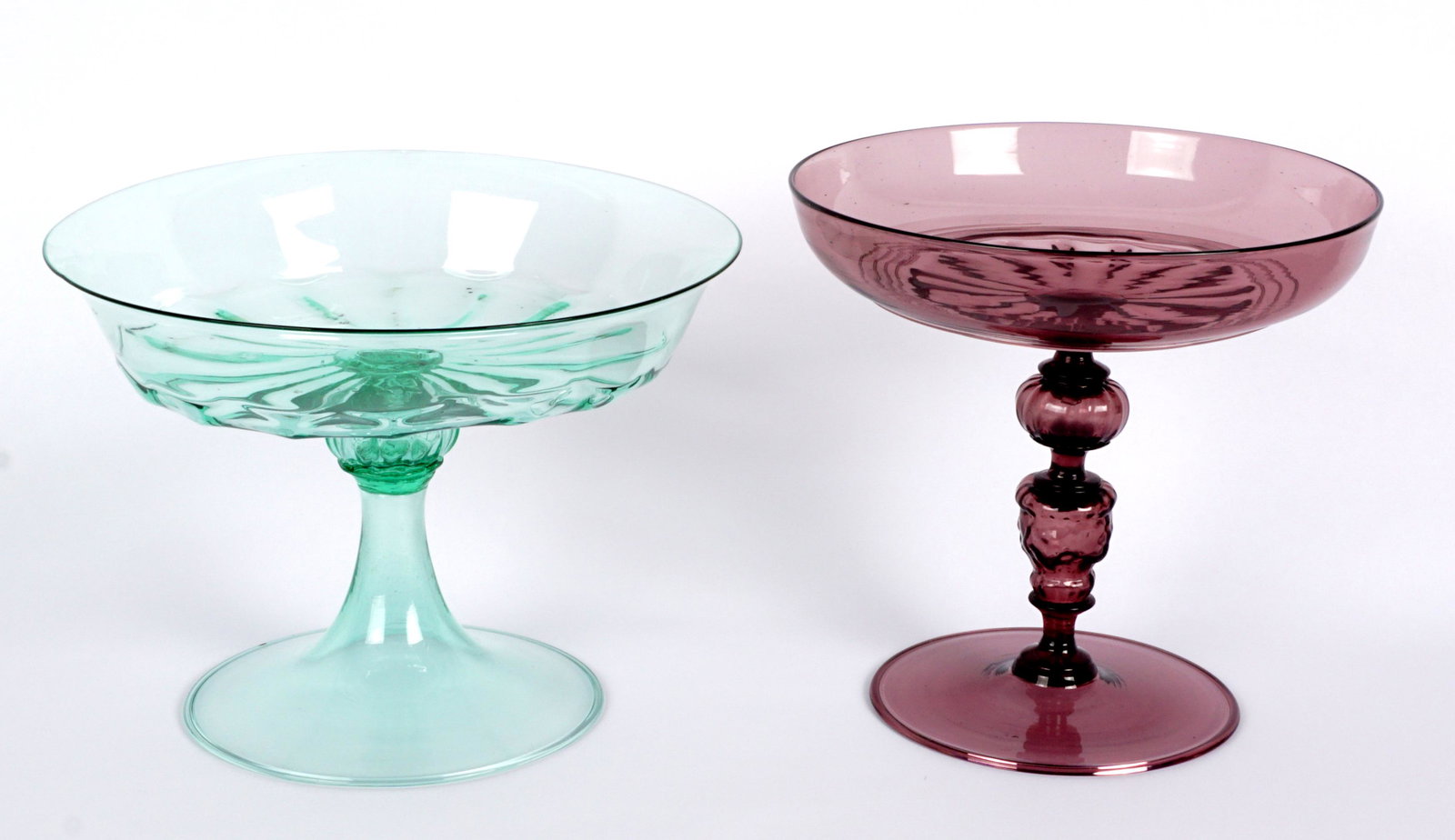 Two Venetian Glass Tazzas: Two pieces total Venetian / Murano glass to include 1) Green glass with fluted base to top bowl, flared rim, flares pedestal foot, unmarked 7" h. x 9.25". Condition: Pontil scar inside top, multiple b