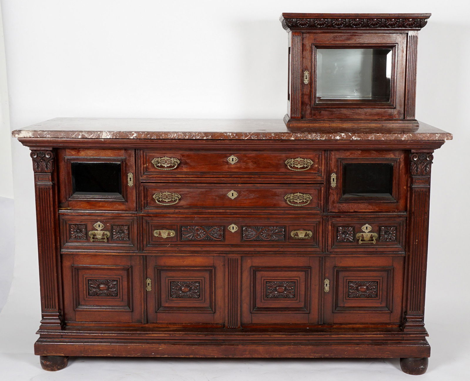 Victorian Marble Top Hat Box Dresser: Mahogany hat box with carved crest and beveled glass door sits atop variegated marble top. Dresser with two center drawers flanked by two beveled glass doors over three drawers over four doors. Fluted