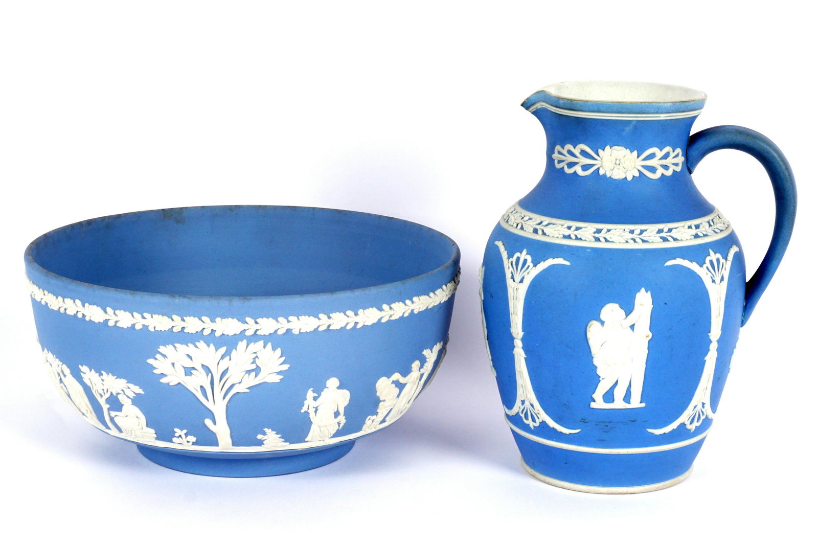 Wedgwood Jasperware Pitcher and Bowl: Two pieces light blue Wedgwood to include 1) Light blue center bowl, white neoclassical motif, stamped on base, 3.75" h. x 8". 2) Light blue pitcher, white cherub and columns decoration, stamped on ba