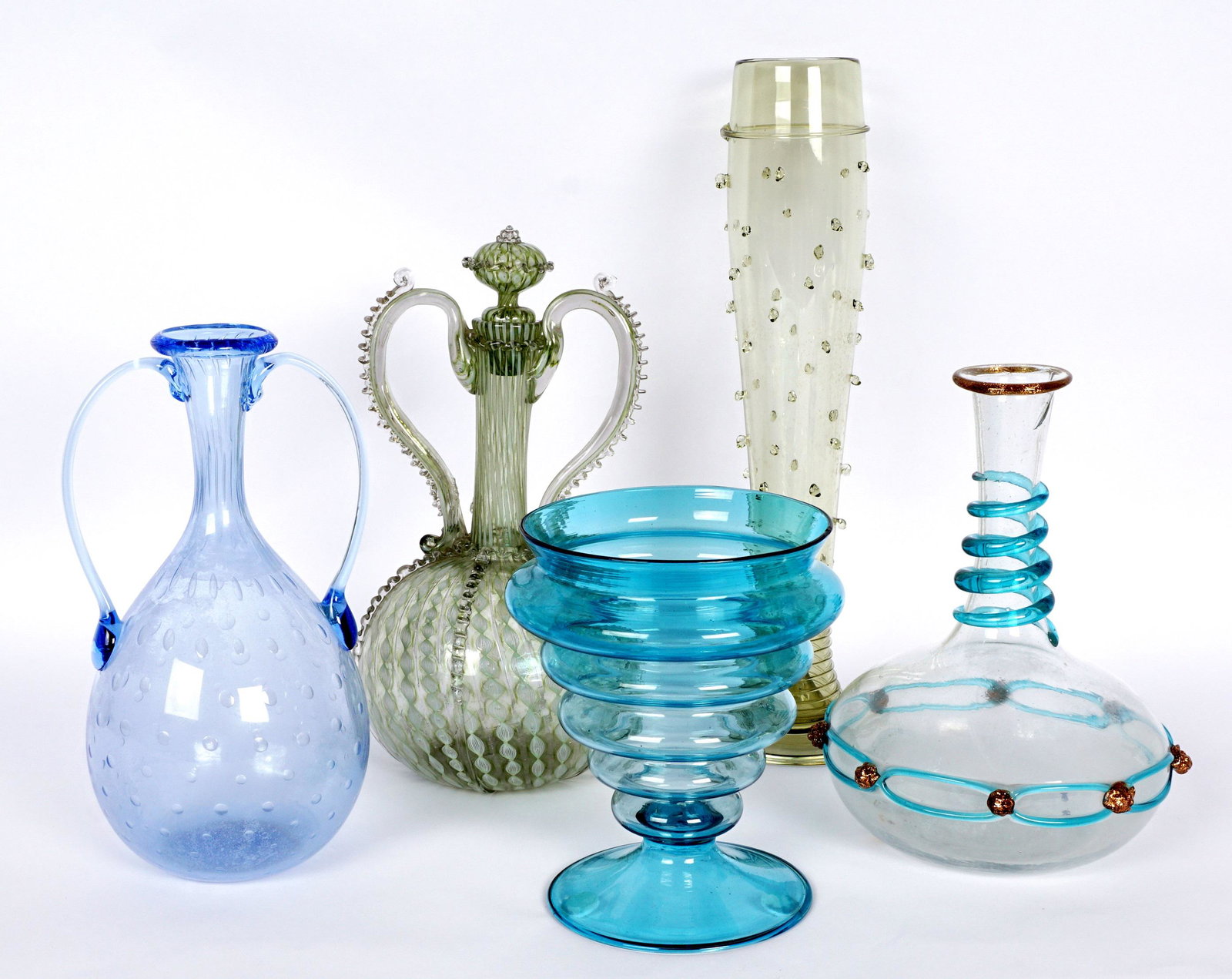 Five Piece Assorted Worldly Art Glass Collection: An assembled collection of five pieces total to include 1) Murano clear glass bottle, aventurine rim, heavy blue threading on neck and body, applied aventurine buttons, 7.75" h. x 6", note sickness. 2