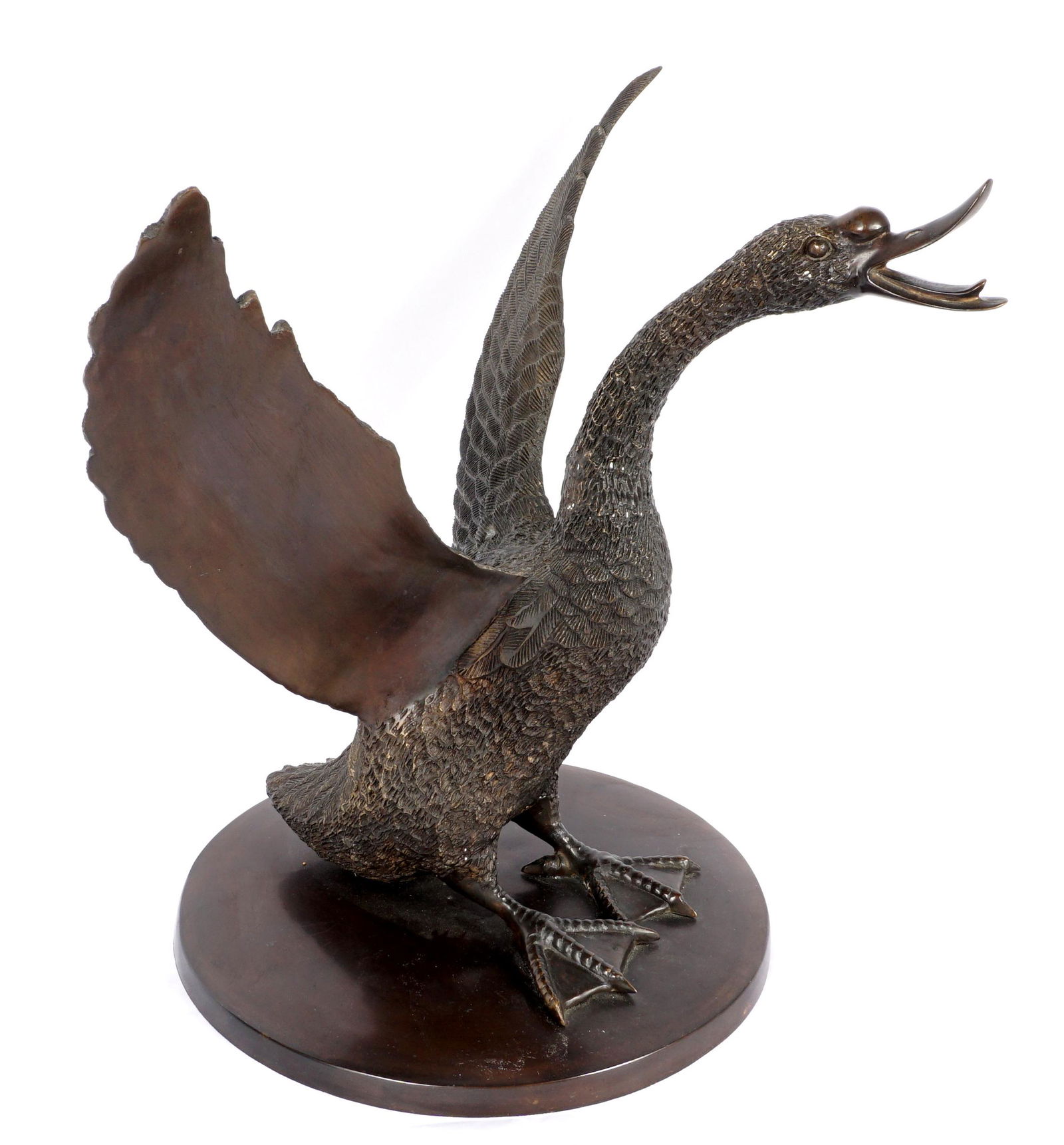 Bronze Figure of A Goose: 20th Century patinated bronze figure of a goose with head up and wings out, no visible signature, overall 17" h. x 16.5" x 16.5".