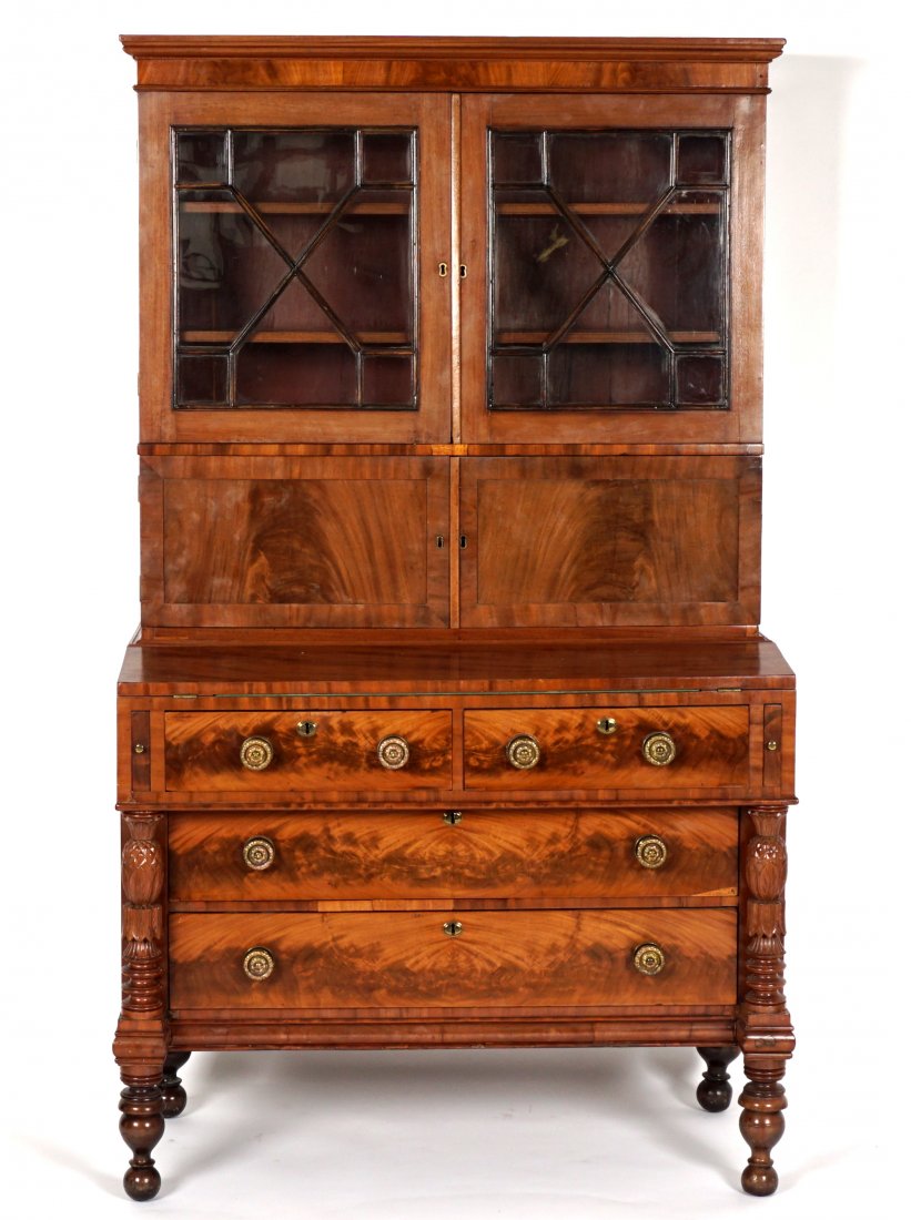 19th C. New England Mahogany Secretary Bookcase: Circa 1840, most likely produced in New England, two filigree glass doors over two blind doors which open to fitted interior, six drawers over valanced cubby holes. Base with hinged lift top felt line