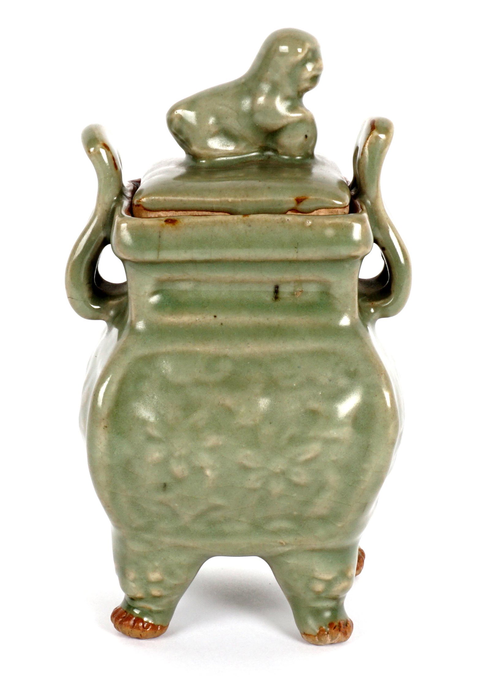Chinese Song Style Longquan Celadon Censer: Covered censer, Longquan style celadon green crackle glaze, lid with figural foo dog finial, double handle body with raised decoration, on four feet. Overall 6.5" h. x 3.5" x 3.5". Sold with copy of o