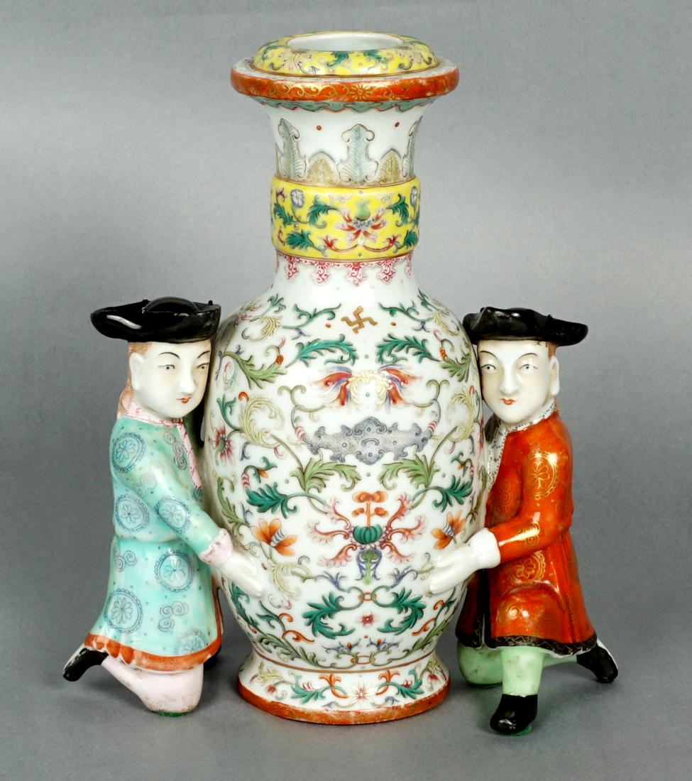 Chinese Qing? Famille Rose Vase with Figures: Bottomless baluster form vase with intricate floral decoration all over, kneeling male figures with tri-corner hats either side, older illegible collection labels on base, overall 9.25" h. x 8". Condi