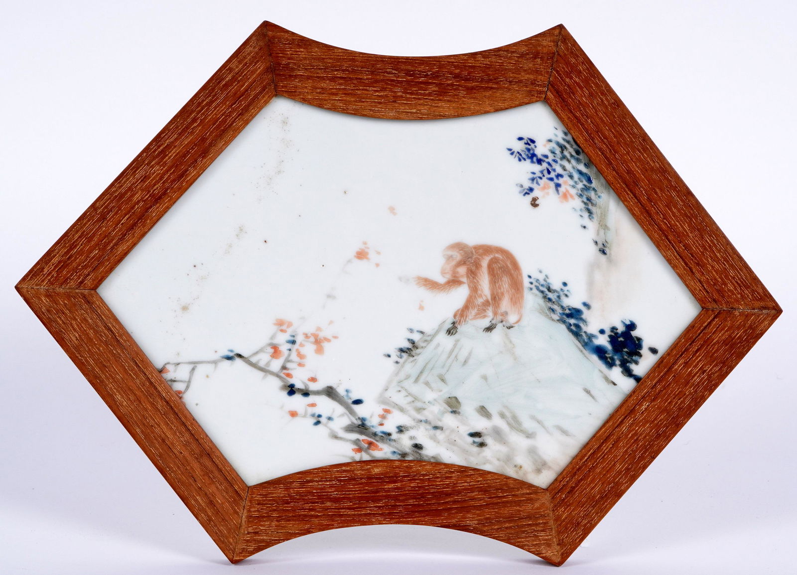 Chinese Famille Rose Porcelain Monkey Plaque: Qing? shaped porcelain plaque, monkey sitting on a rock in landscape, no visible markings, 10.25" x 7", framed 12" x 8.75". Condition: Wear to decoration.