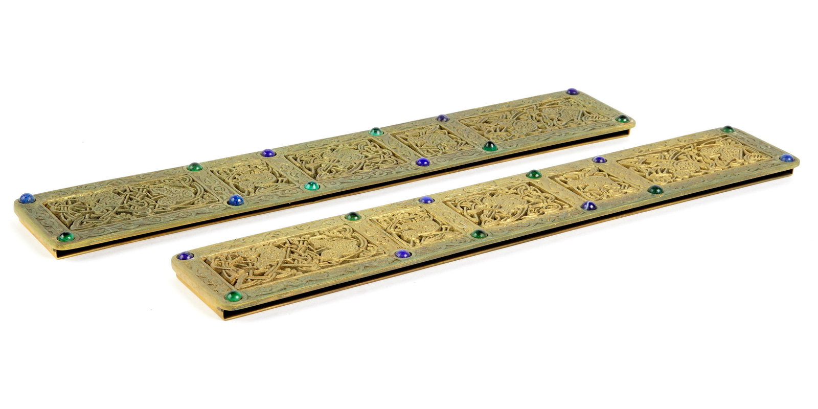 Tiffany Studios Bronze 9th Century Blotter Ends: Gilt bronze shorter blotter ends in the Ninth Century pattern by Tiffany Studios, accented with glass jewels, well marked Tiffany Studios, New York, 1623, 12.25" x 2". Condition Uneven finish, verdigr