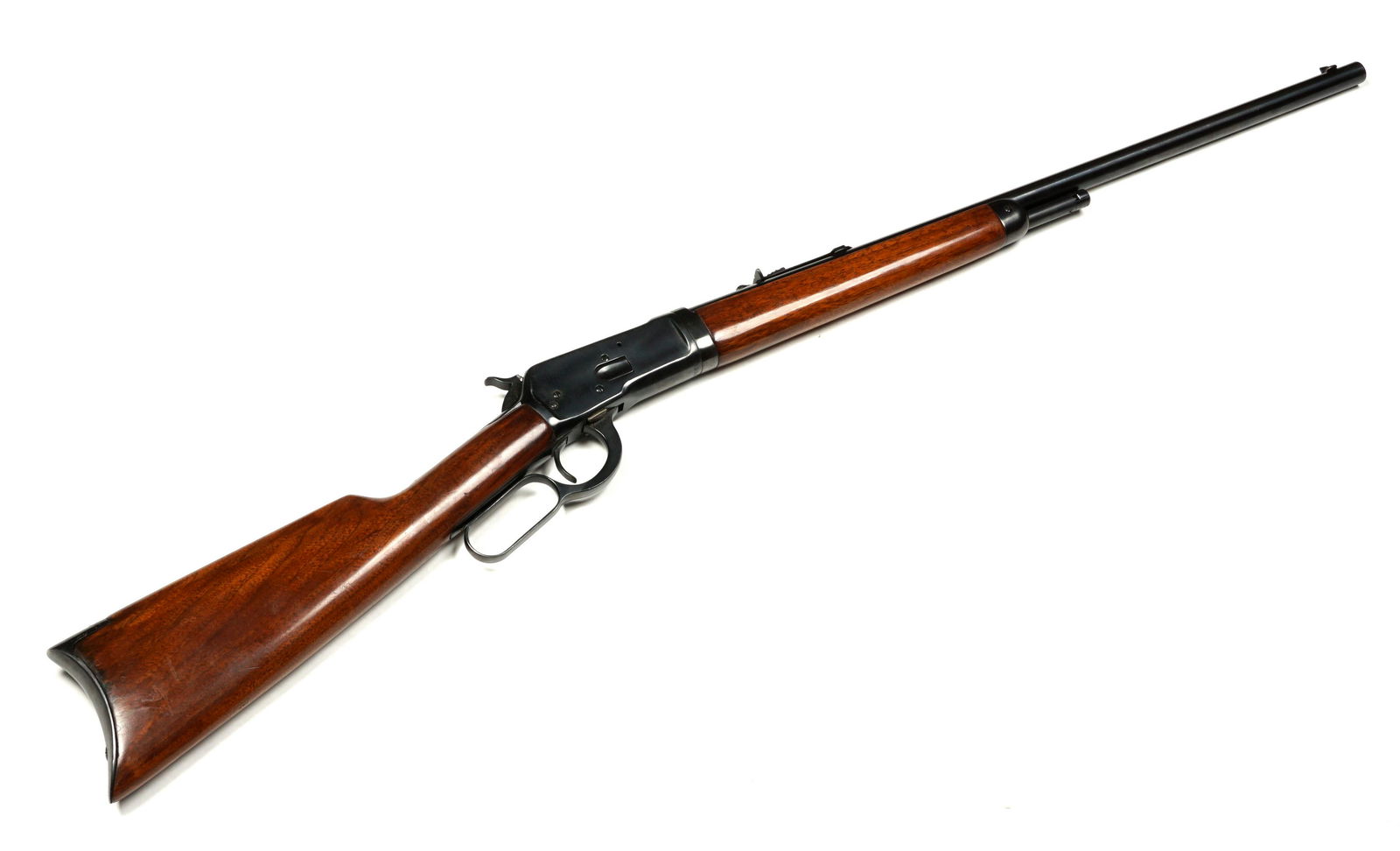1924 Winchester Model 1892 Lever Action Rifle: .32 WCF caliber 24" round barrel, walnut stock, shortened magazine, crescent steel butt, serial number 932052, circa 1924. Well marked in appropriate places, overall 42" long, length to pull 14". Cond