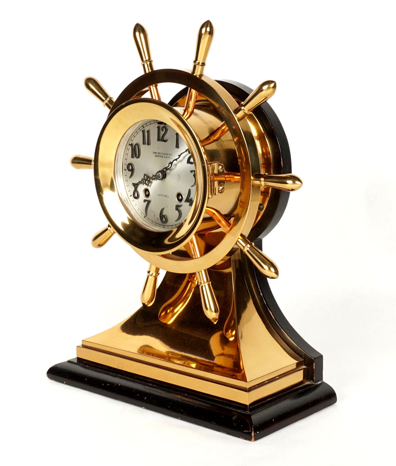 Chelsea Brass Yacht Wheel Ship's Bell Clock: Circa 1920's, Chelsea Clock Co. polished brass "Yacht Wheel" case clock. Ten spoke wheel design, silvered dial marked "Chelsea Clock Co., Boston, USA, Ships Bell", also marked on back with patent date