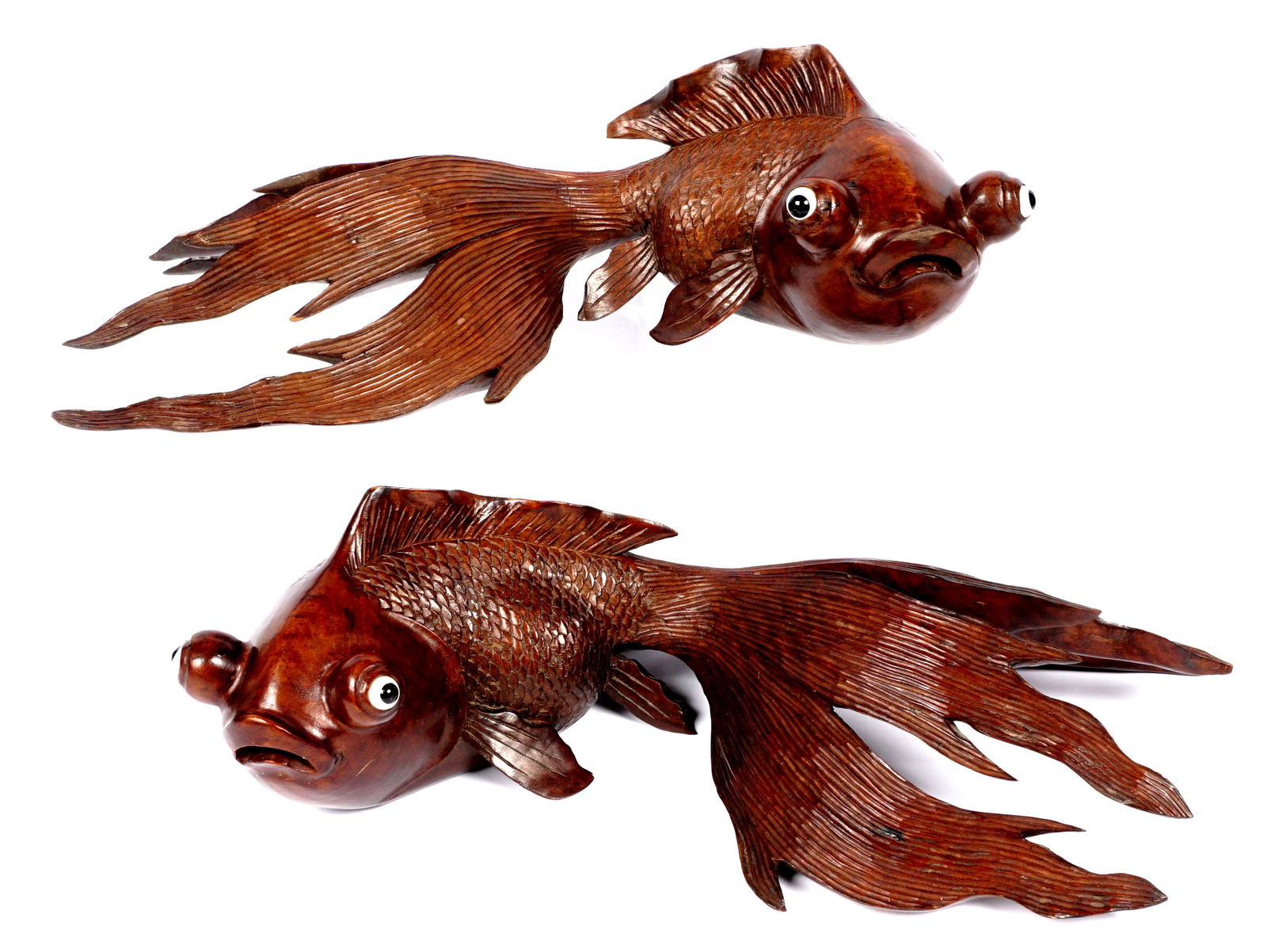 Pair Large Chinese Carved Hard Wood Goldfish: Pair of large hand carved Chinese figural goldfish or koi with glass eyes. Each measures approx .6" h. x 19.5" x 12" Condition: Minor chips and splits on tails. Cracks to body