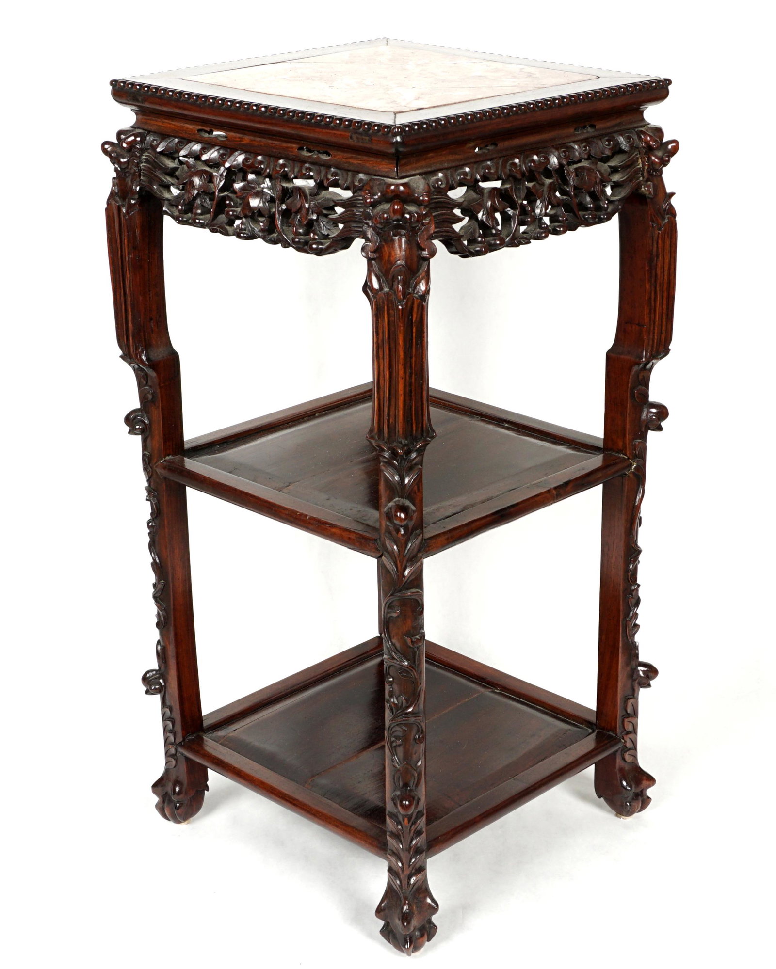 Chinese Marble Inset Plant Stand: Square marble inset top, pierce carved skirt with masks at corners, two lower shelves, carved legs, ball and claw feet. Overall 32" h. x 15.75" x 15.75". Condition: Cracks to marble, other wear consis
