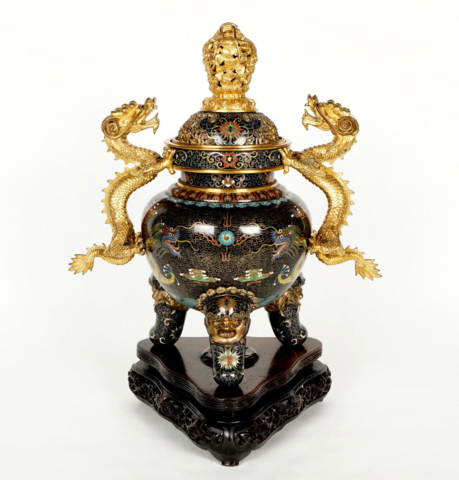 Chinese Cloisonne Dragon Censer on Stand: Well executed Chinese cloisonne censer, pierced lid with dragon in clouds finial, two gilt figural dragon handles, black ground body with five-toed dragons and flaming pearls, tri foot base, masks at