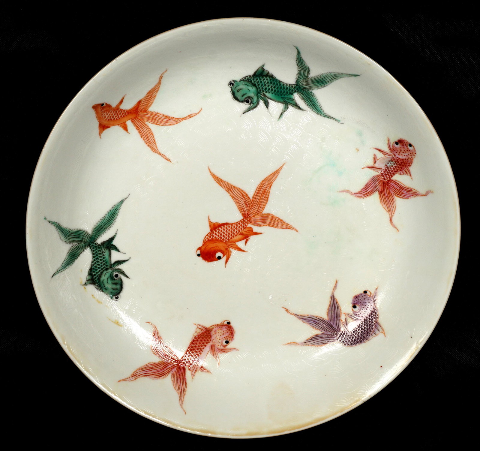 Chinese Goldfish Decorated Dish: 20th Century Chinese plate polychrome decorated with swimming goldfish decoration, marked on base with spurious six character Jiaqing mark, overall measures 1.5" h. x 9.5".
