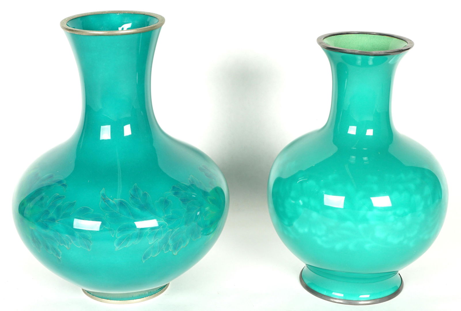 Two Green on Green Chinese Enameled Vases: Two vases total to include 1) Squat form vase with foliate cloisonne enamel decoration, unmarked, 11" h. x 9". 2) Bulbous vase with subtle floral decoration, unmarked, 10.25" h. x 7".