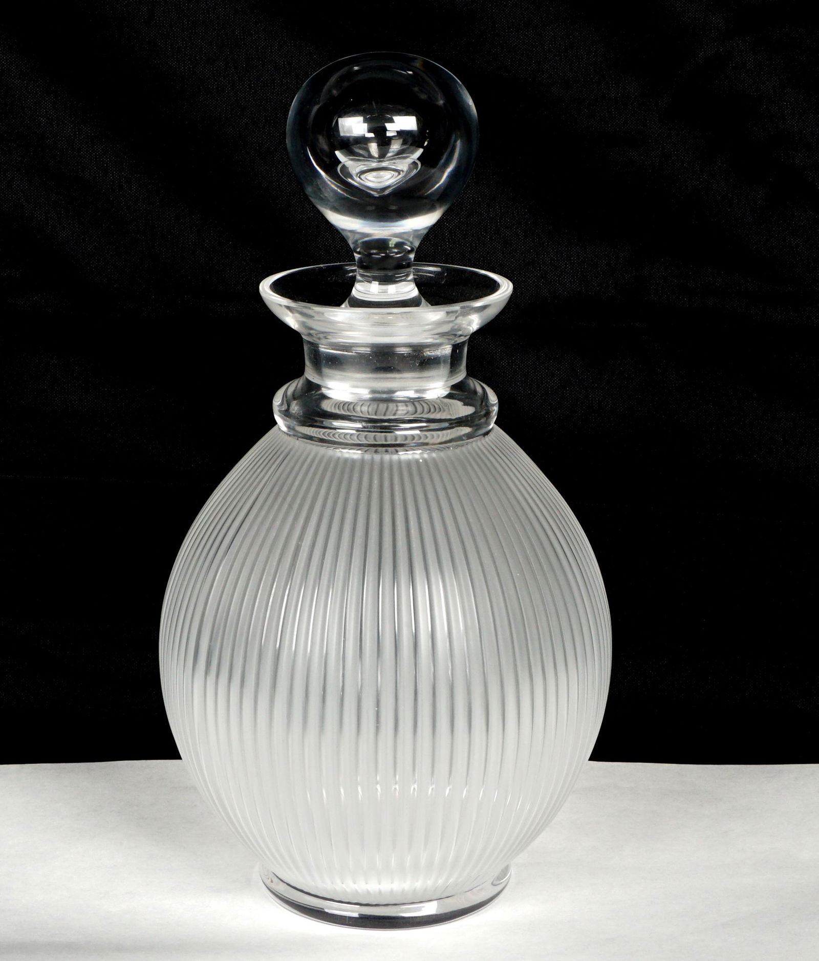 Lalique Langeais Crystal Decanter: Frosted ribbed body, clear base, neck and stopper, etched signed on base, overall 9.25" h. x 5.25".