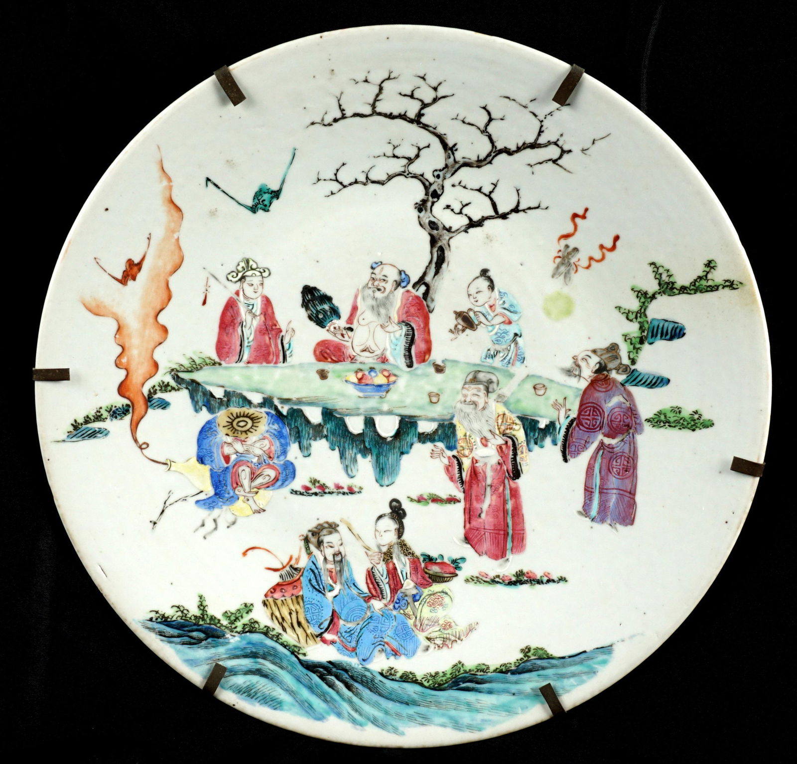 Large Chinese Qing? Famille Rose Charger: Famille Rose charger, most likely 19th Century, enamel outdoor genre scene with figures at a table, unmarked, applied metal hanging ring, 2.25" x 16.5". Condition: Wear to decoration.
