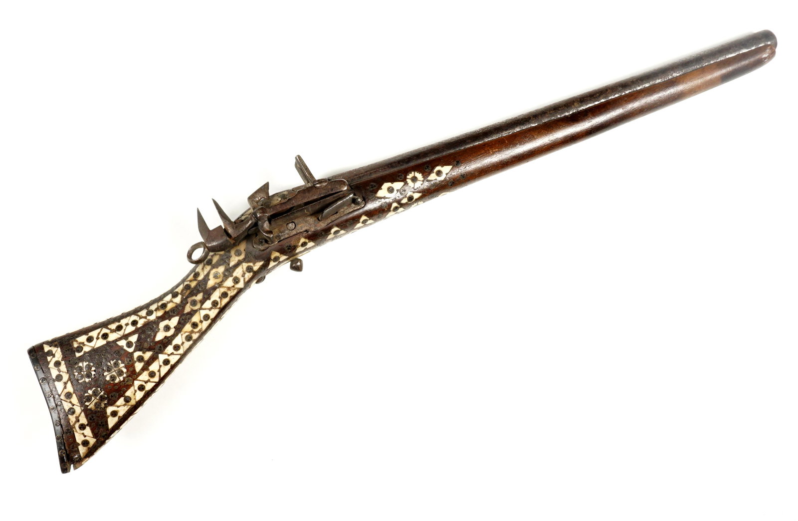 18th C. Inlaid Ottoman Flintlock Pistol: Circa 1700's, 14" steel barrel with engraving and armourer stamps near tang, miquelet lock, stock with geometric bone inlays, overall 22.5" long. Condition: Chips and loss to inlay and stock, lock is