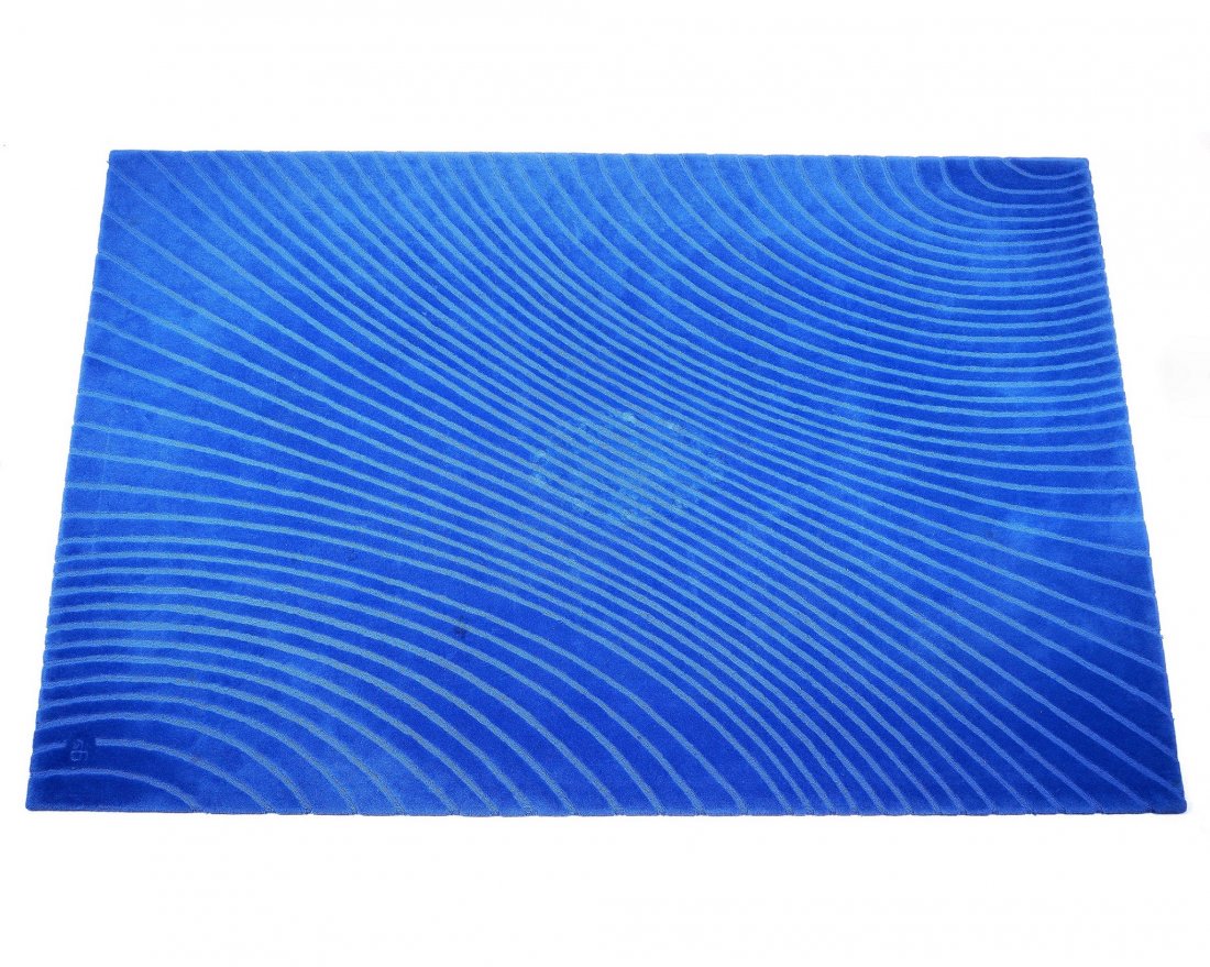 Della Robbia Studio DR Stretch Wool Carpet: Contemporary "Stretch" pattern New Zealand wool sculpted blue rug, labeled verso, overall 7' 7" x 12'. Condition: Several stains and center impression.