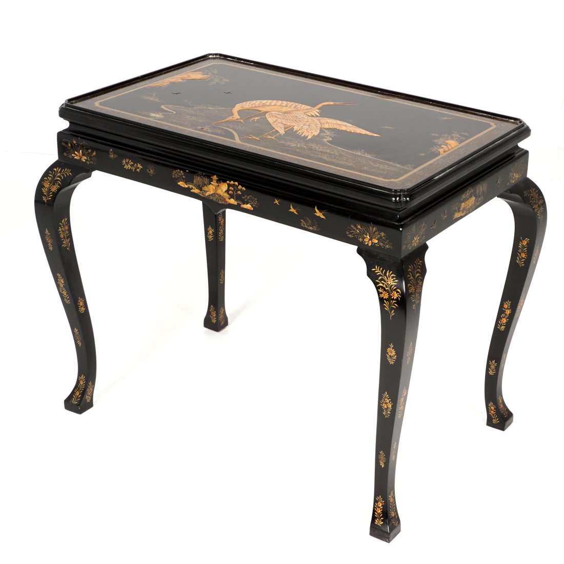 Baker Furniture Black Lacquer & Gilt Tea Table: Gilt decorated black lacquer finish, top with cranes in landscape, skirt with buildings and floral motifs, floral decorated shaped legs. Overall 22.5" h. x 34.5" x 22.5".