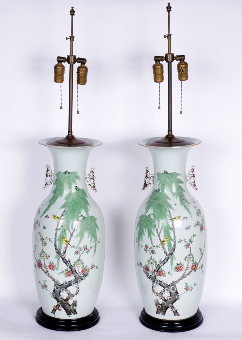 Pair Large Chinese Vases Mounted as Lamps: Baluster form porcelain vases with applied handles, polychrome birds and butterflies in flowering branches motif, wood base, double socket fixture, no shades. Overall 40".5" h. x 9.5". Condition: Rim