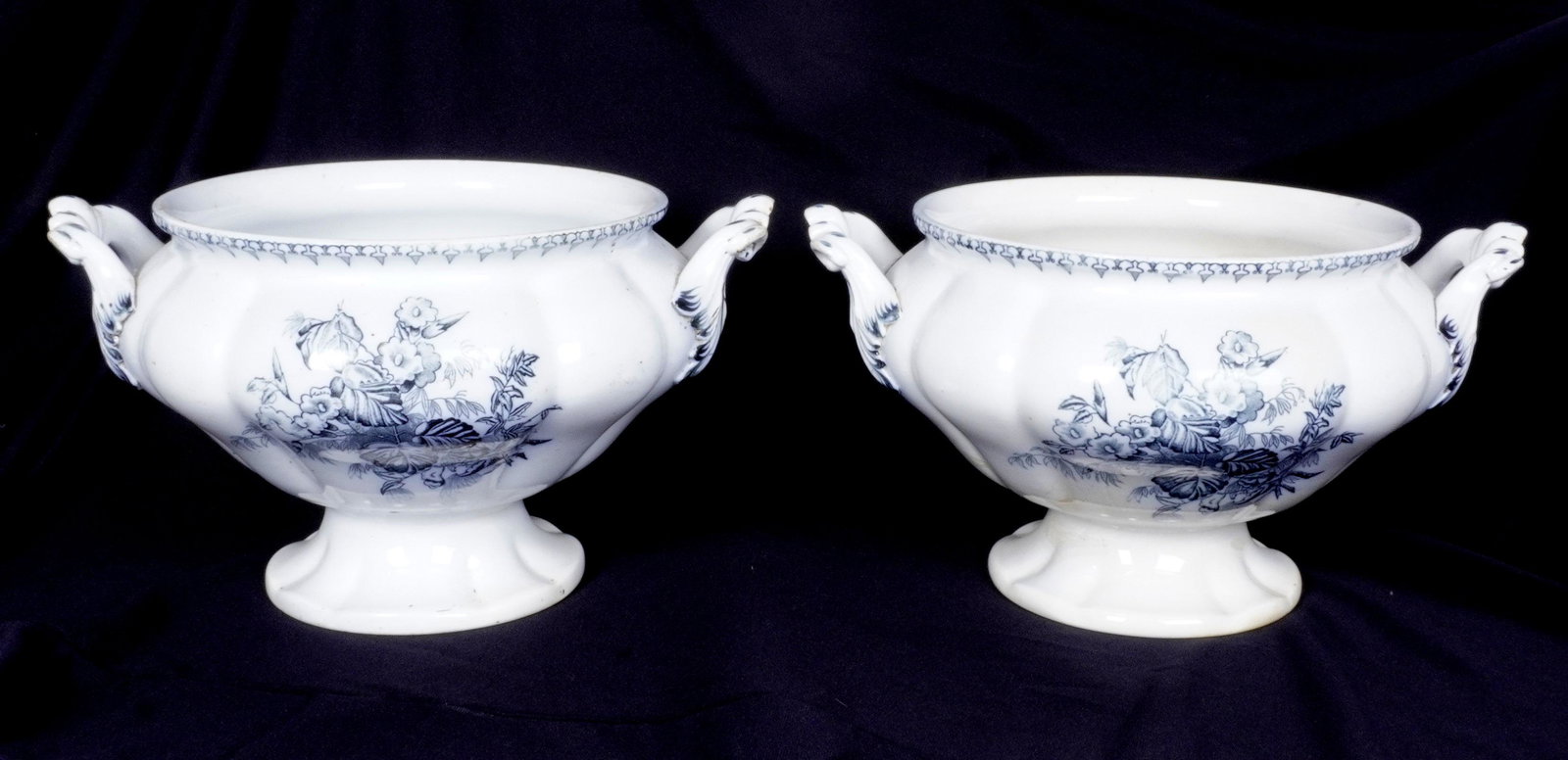 Pair Large Russian Porcelain Tureens: White ground porcelain tureens, blue floral transfer deigns, applied handle. Marked on foot. No lids. 8" h. x 14". Condition: Chips and discoloration.