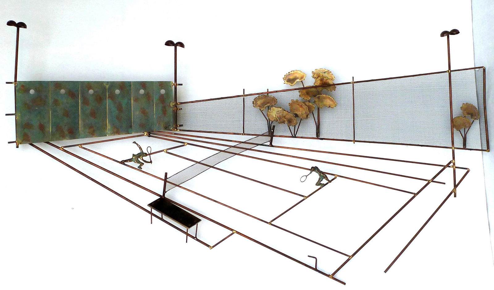 Curtis Jere Copper Tennis Court Wall Sculpture: Wall sculpture depicting a tennis match, signed C. Jere, overall 28" h. x 52.5". Condition: Small break to mesh, missing one hook.