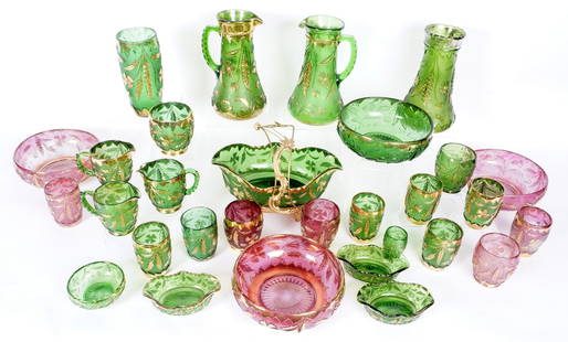 30 pc Thistle Motif Pattern Carnival Glass Items: 30 pieces total in green and amethyst with gilt accents, thistle motif exterior, to include 2 pitchers (9.25" h.); 2 vases (taller 9.25"); center bowl with gilt metal stand (overall 8.75" h. x 11.5"