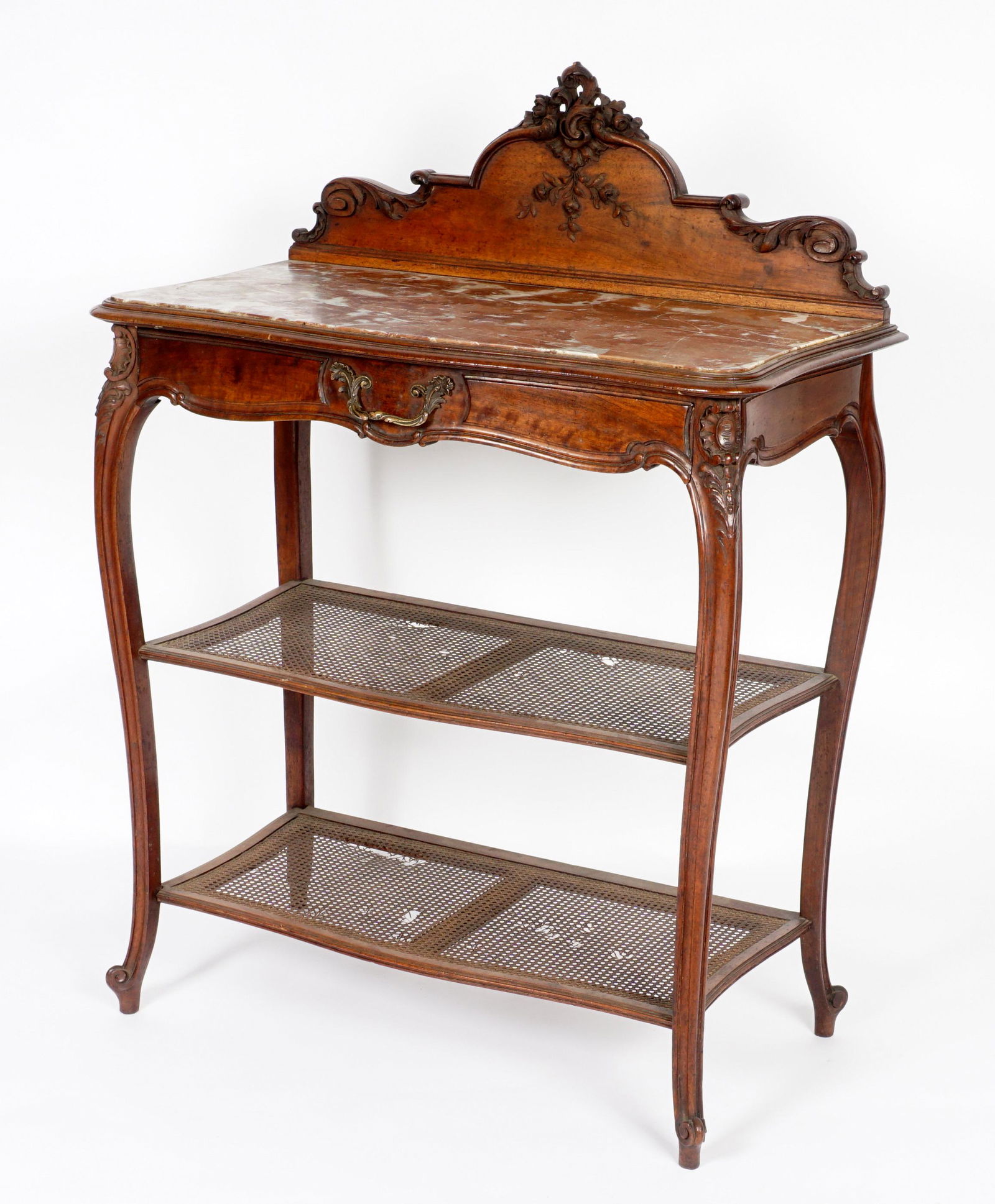 French Marble Top Server: Foliate scroll crest over inset serpentine marble top. Two lower caned shelves, shaped legs ending in scroll feet. Overall 46" h. x 33.5" x 17.75". Condition: Breaks in caning, other wear consistent w