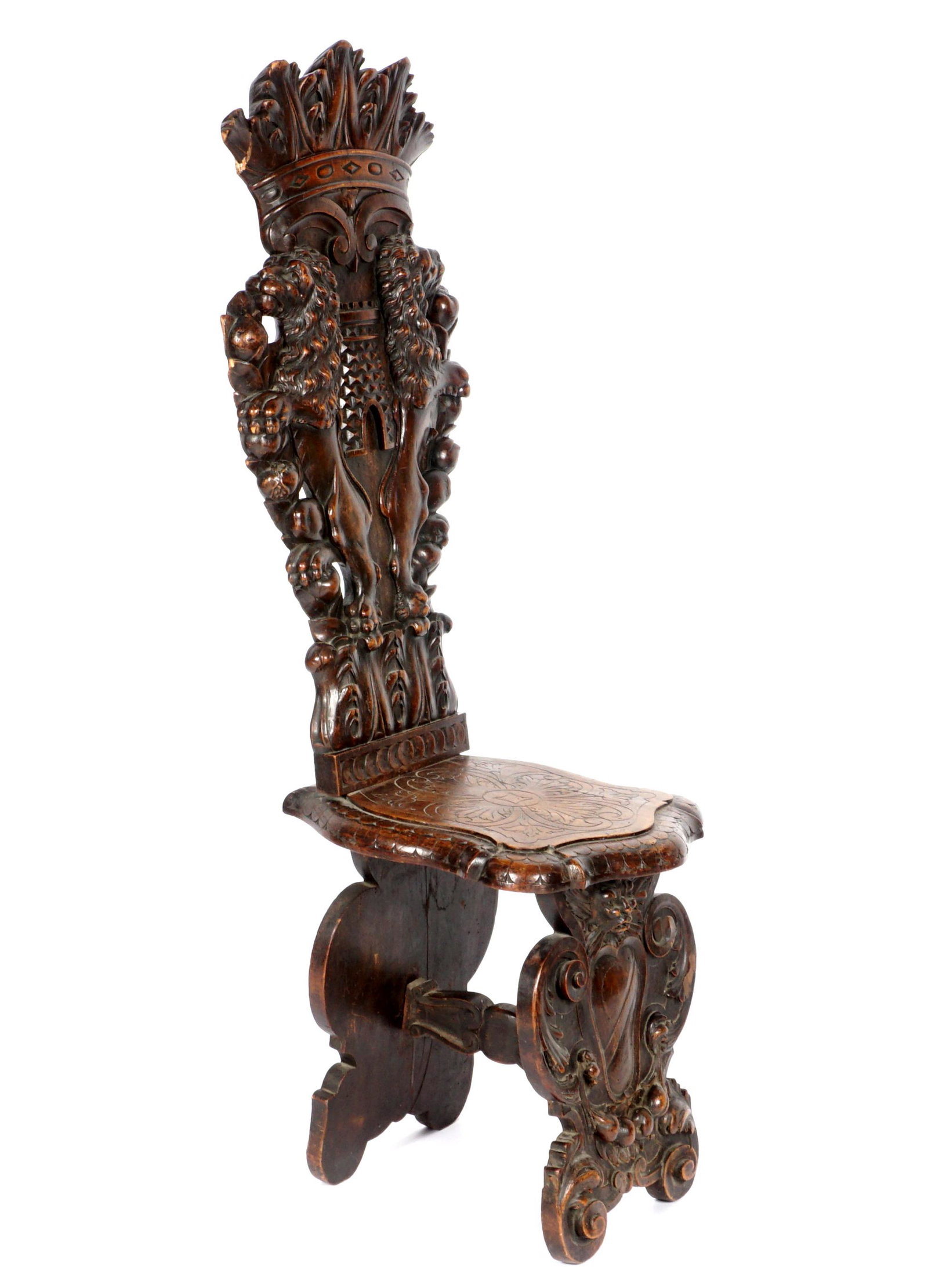 Italian Baroque Style Carved Side Chair: Back profusely carved with crown over rampant lions and castle, floral motifs. Front support with mask over shield and foliate scroll. Overall 55" h. x 16" x 21". Condition: Multiple repairs, further