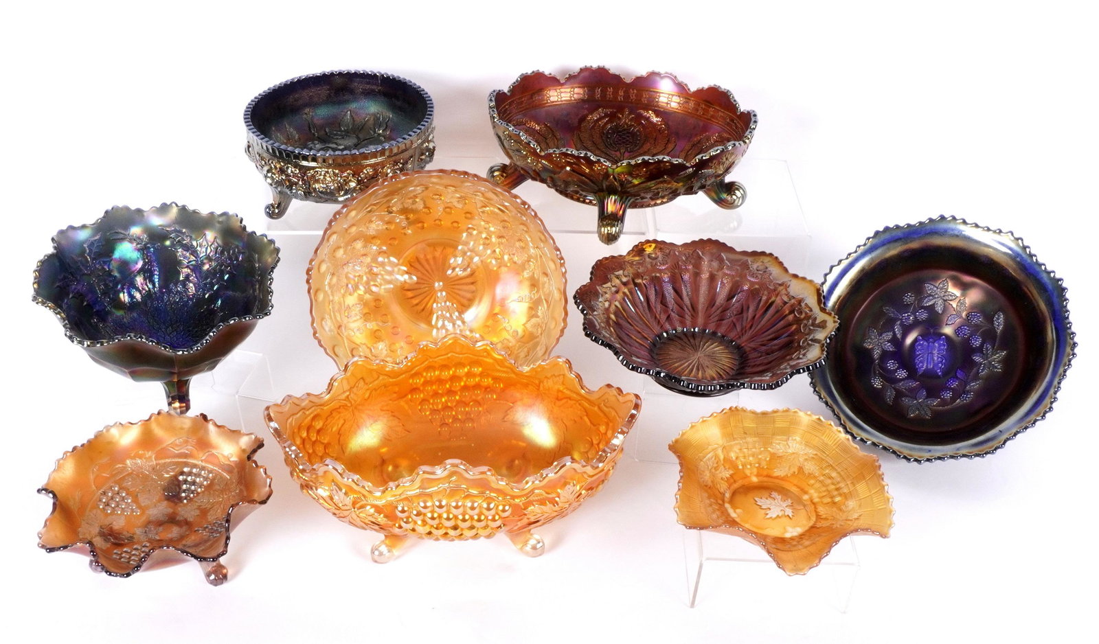 Nine Piece Assorted Carnival Glass Bowls: Nine pieces total to include 1) Millersburg Vintage Hobnail bowl, 10" dia. 2) Fenton Stag & Holly footed bowl, 5" x 9". 3) Fenton Butterflies & Berry footed bowl, 3.5" x 10". 4) Grape and Cable basket