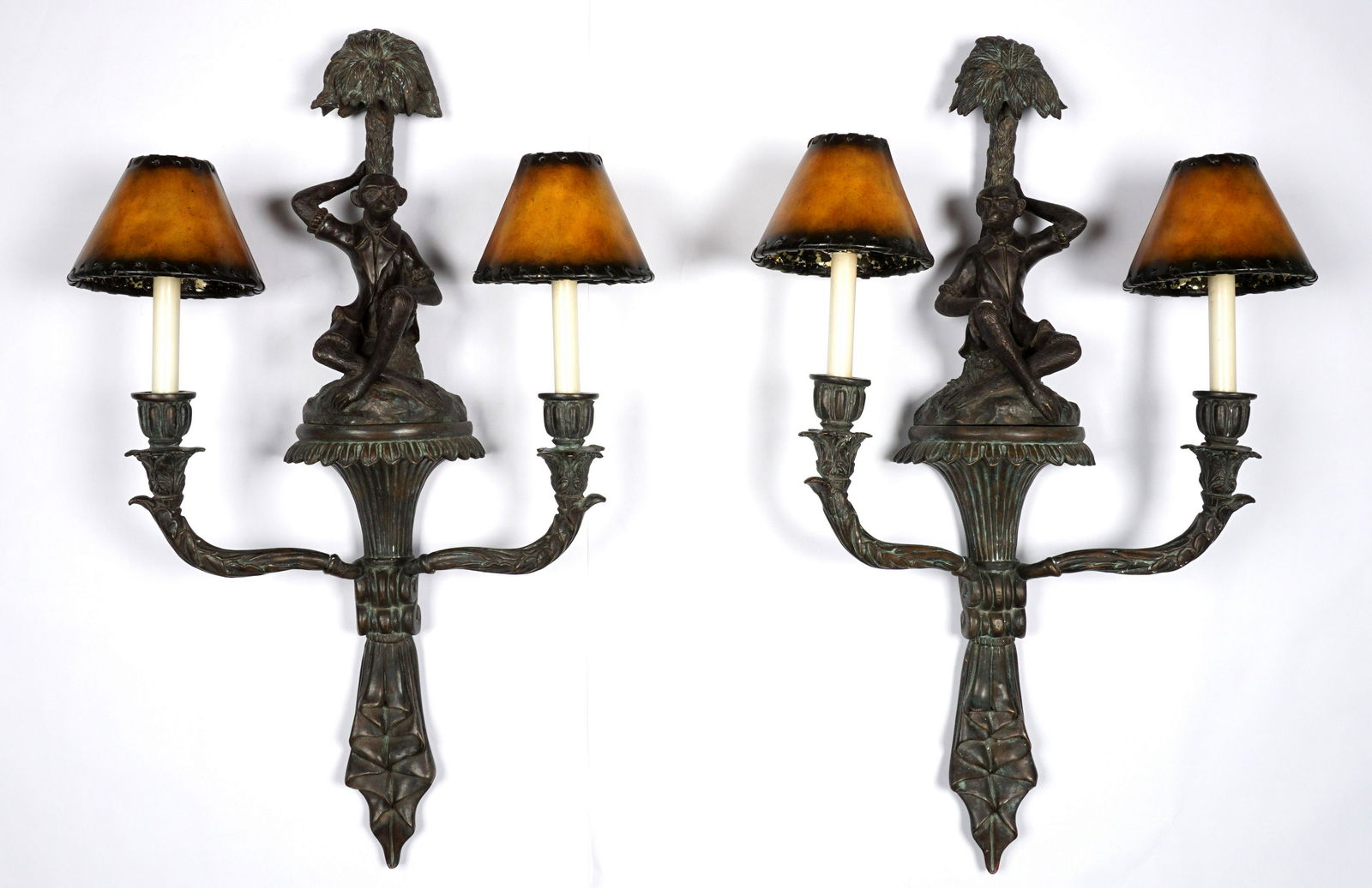 Pair Bronze Maitland Smith Figural Monkey Sconces: Each with figural monkey and palm tree, two arms, leather shades, Maitland-Smith label verso, 37" h. x 18.5" x 6.75".