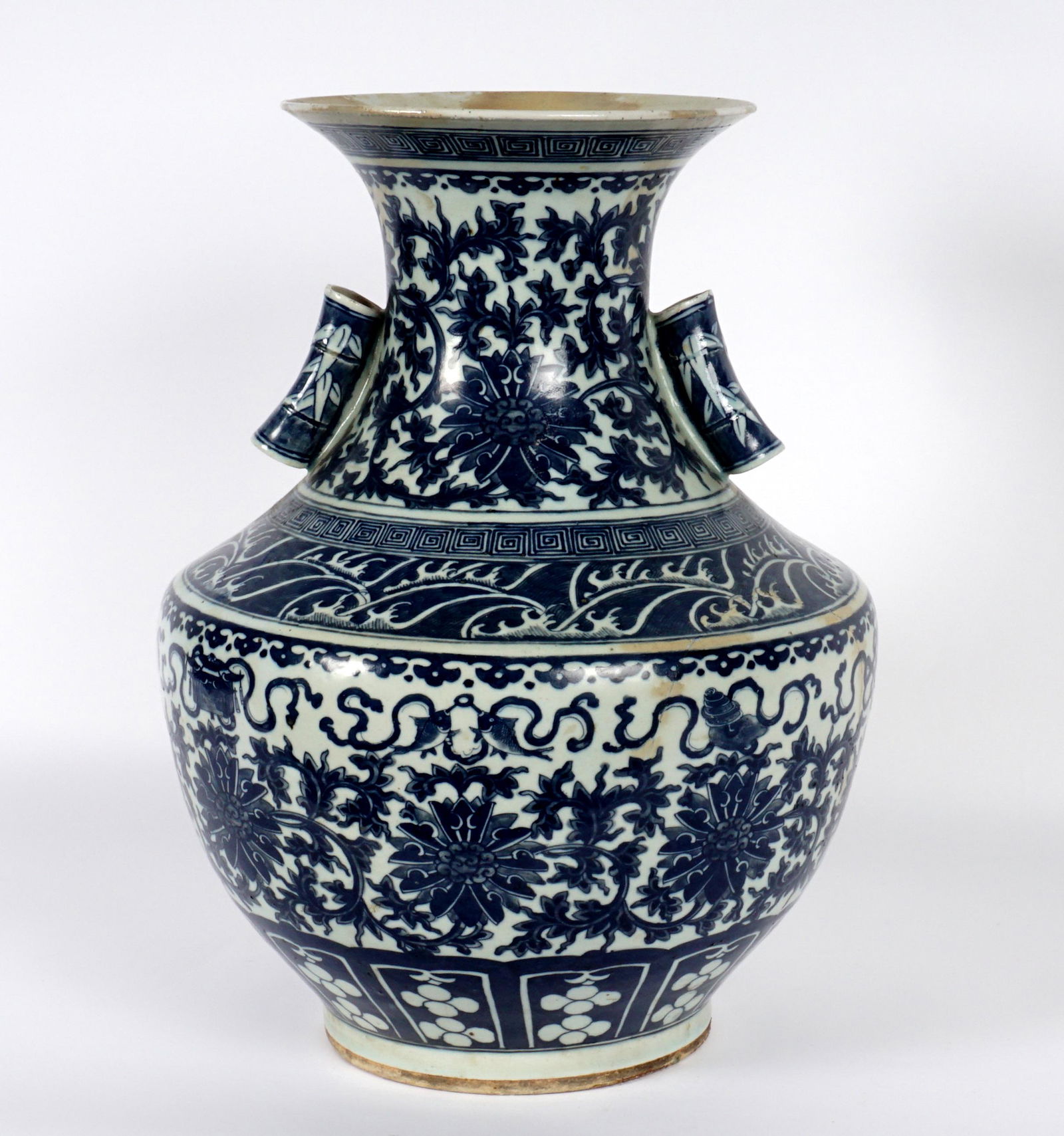 Large Chinese Blue and White Decorated Vase: Large vase with applied hollow bamboo form handles, blue and white decorated with bands of floral, waves, garland with fish designs. Bears a Qianlong 6 character mark on base, actual age unknown. Over