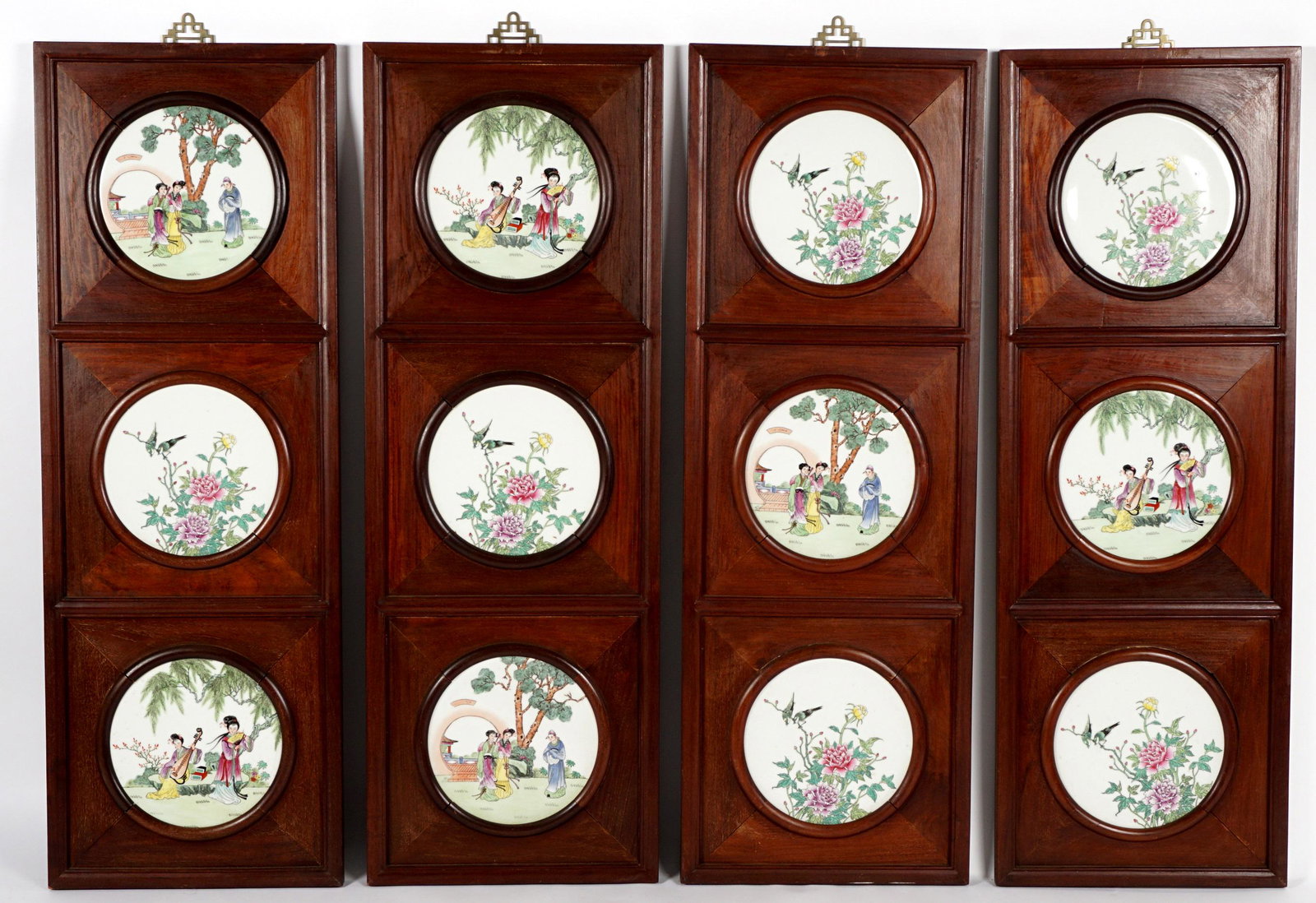Four Chinese Mahogany and Porcelain Tile Panels: Four mahogany wall panels, each with three painted porcelain round plaques, assorted courtyard genre scenes, birds, and flowers. Overall 50.5" h. x 17" x 1.25".