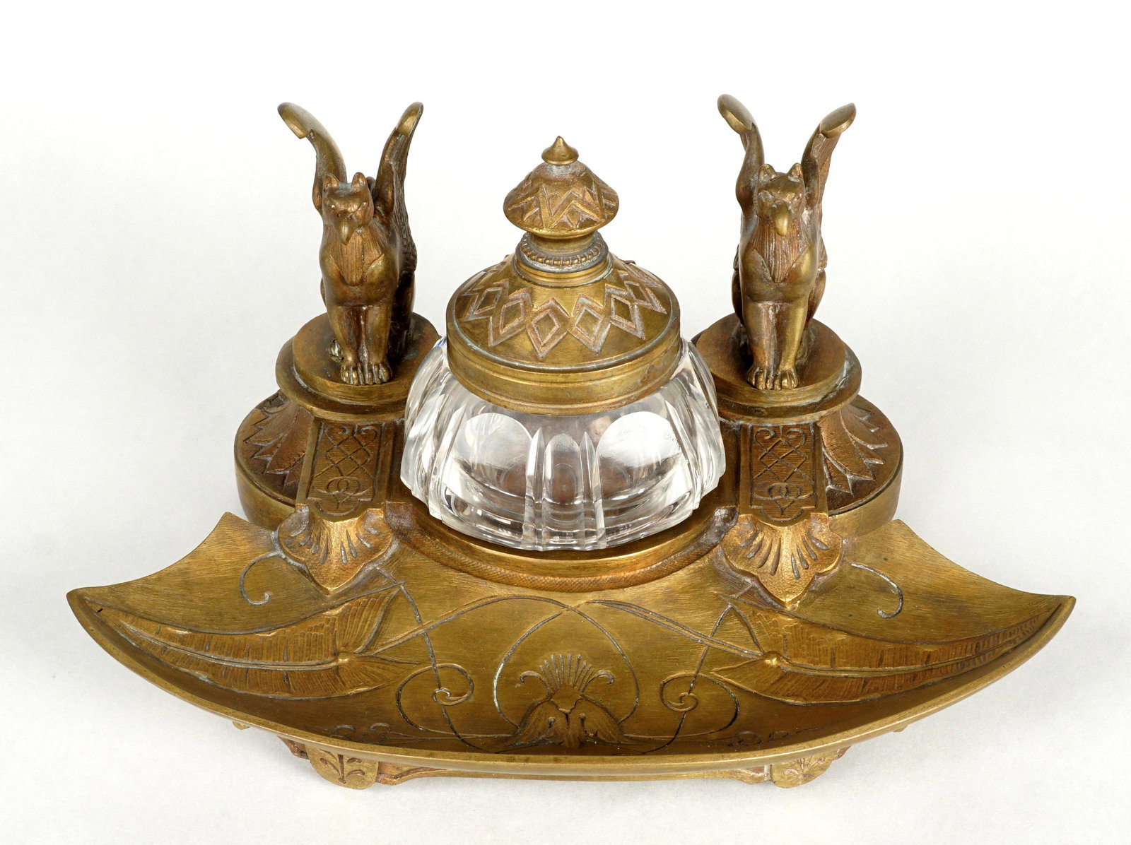 Bronze Figural Griffins Inkwell: Heavy cast bronze inkwell, two figural griffins, cut glass insert, unmarked, overall 3.75" h. x 7.25" x 5.5". Condition: Rim chips to insert.