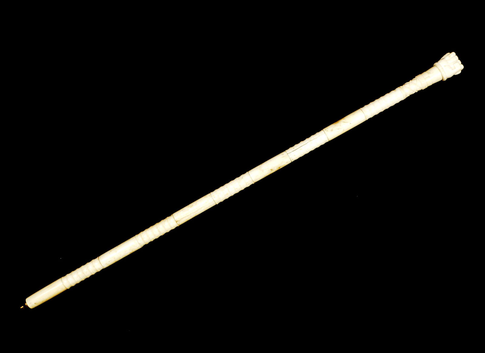 Sailors Carved Bone Fist with Snake Cane: Carved bone grip with squared fist holding a snake over rope lattice panel, alternating smooth and ribbed panels, brass tip. Overall 32.75" long. Condition: Cracks to panels.