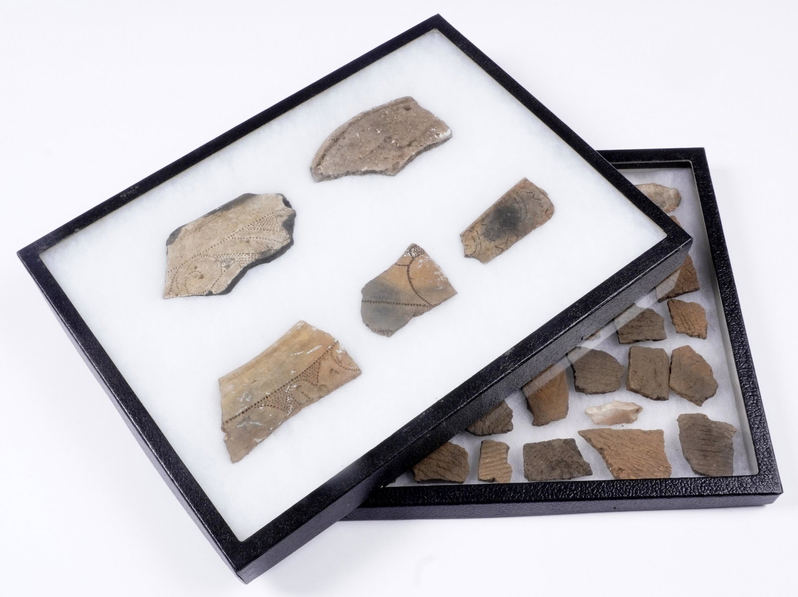 Collection of Native American Pottery Shards: Two 12.25" x 18" Riker mounts with assorted pottery shards. Incised and stippled decoration.