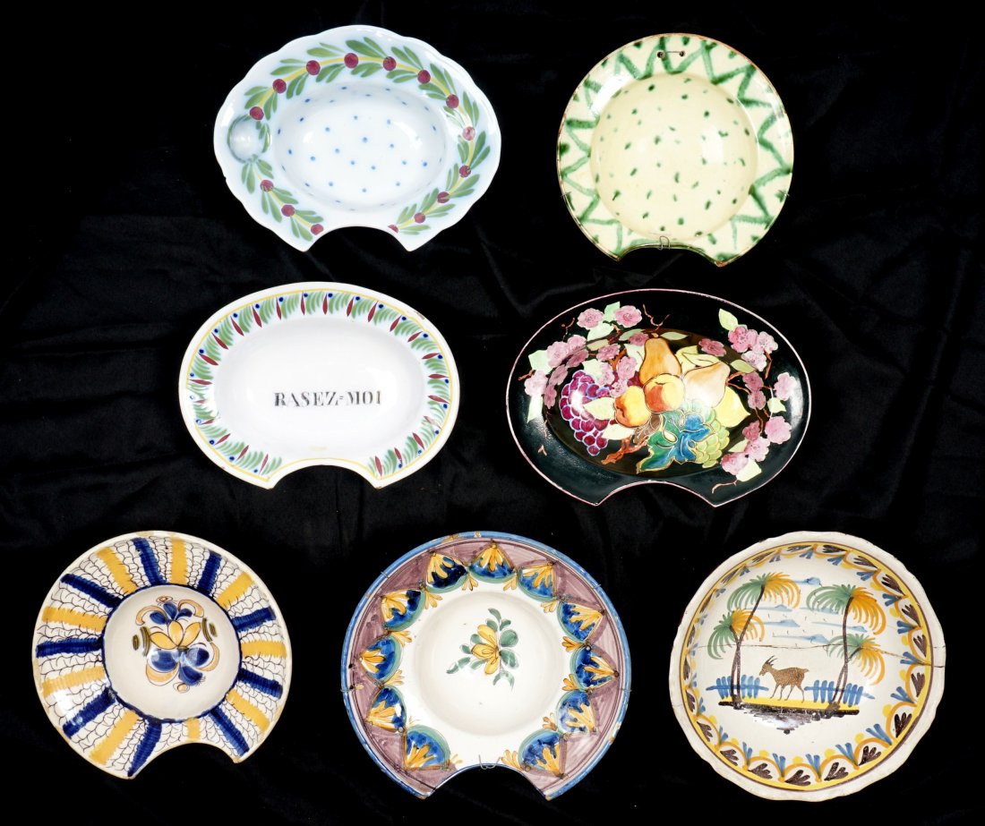 Collection of 7 French Faience Shaving Bowls: An assembled collection of seven 18th / 19th Century shaving bowls, 3" h. x 10.75". Condition: Chips, cracks, and repairs to be expected