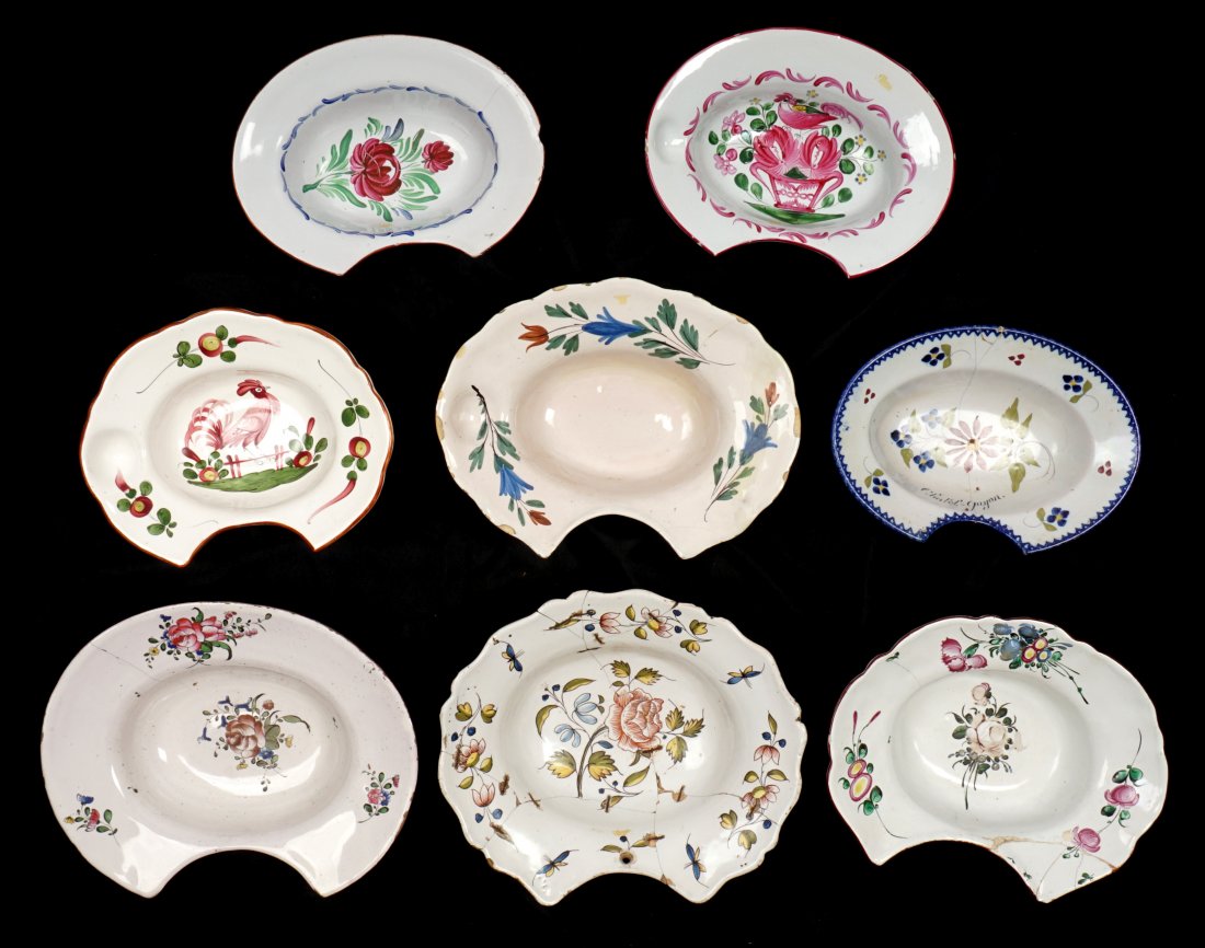 Collection of 8 French Faience Shaving Bowls: An assembled collection of eight 18th / 19th Century shaving bowls, 3" h. x 13". Condition: Chips, cracks, and repairs to be expected.