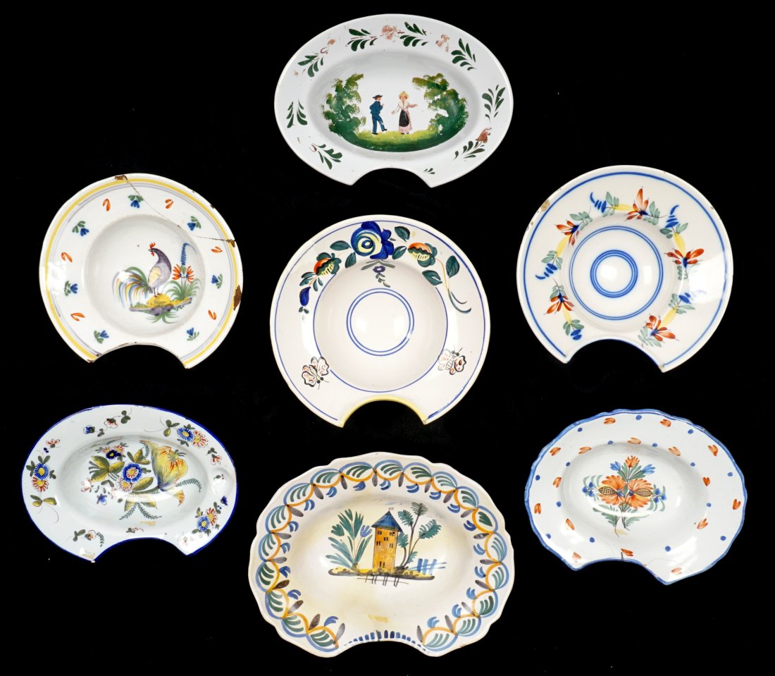 Collection of 7 French Faience Shaving Bowls: An assembled collection of seven 18th / 19th Century shaving bowls, largest 3.25" x 12.25"". Condition: Chips, cracks, and repairs to be expected.